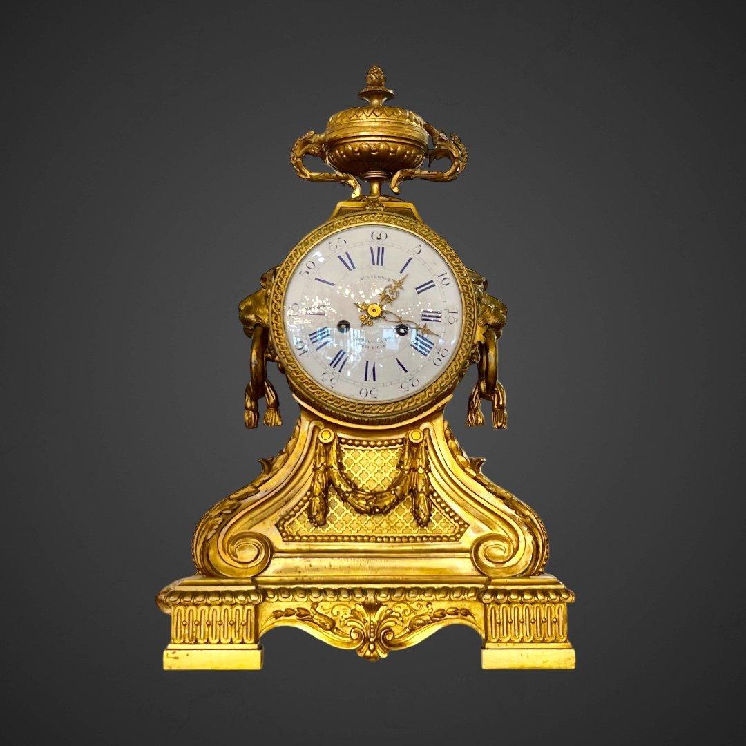 We present you this exquisite and rare 19th-century C. Vernet mantel clock,  embodying a neoclassical design. Crafted with great precision and adorned with fine gilded bronze, the clock's mechanism is enclosed within a substantial drum, embellished