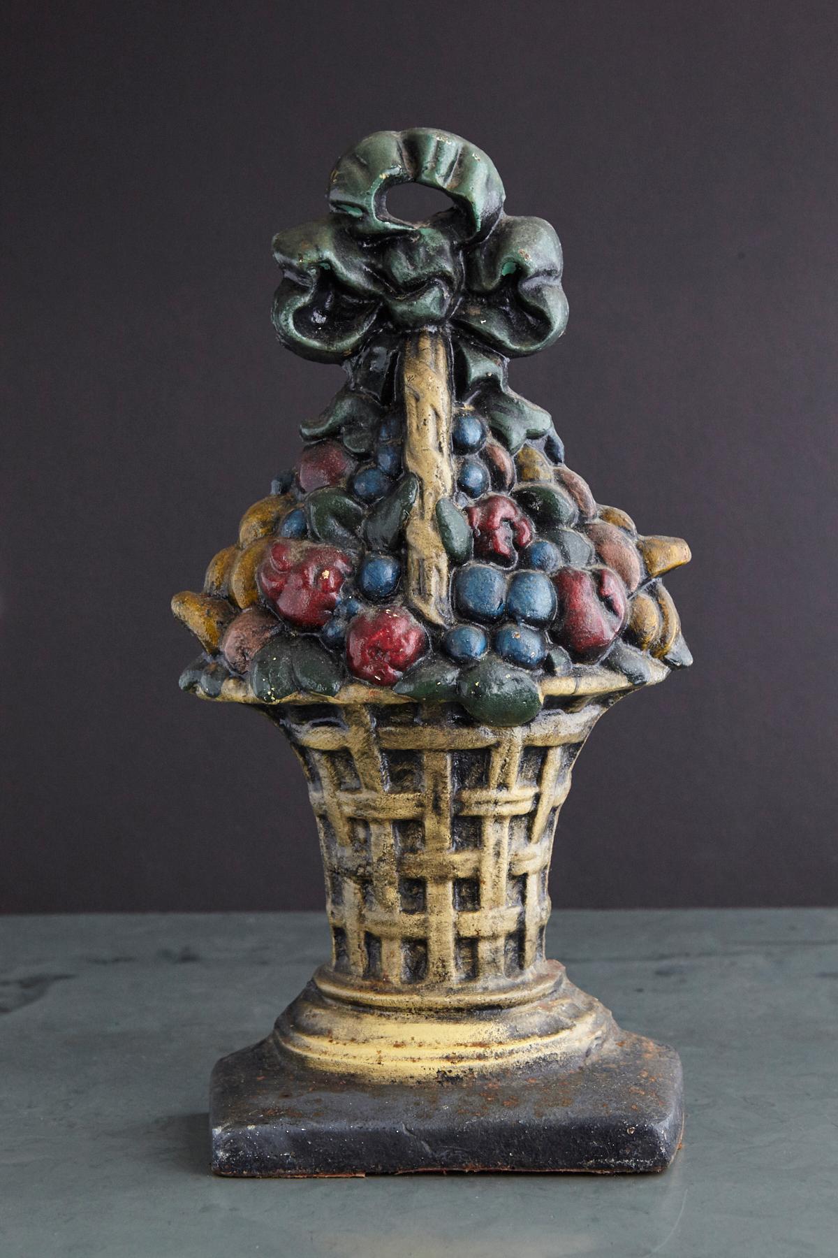 Lovely late 19th century large cast iron hand painted polychrome flower bouquet in basket doorstop with it's original paint and fantastic patina. Heavy, solid piece of iron.