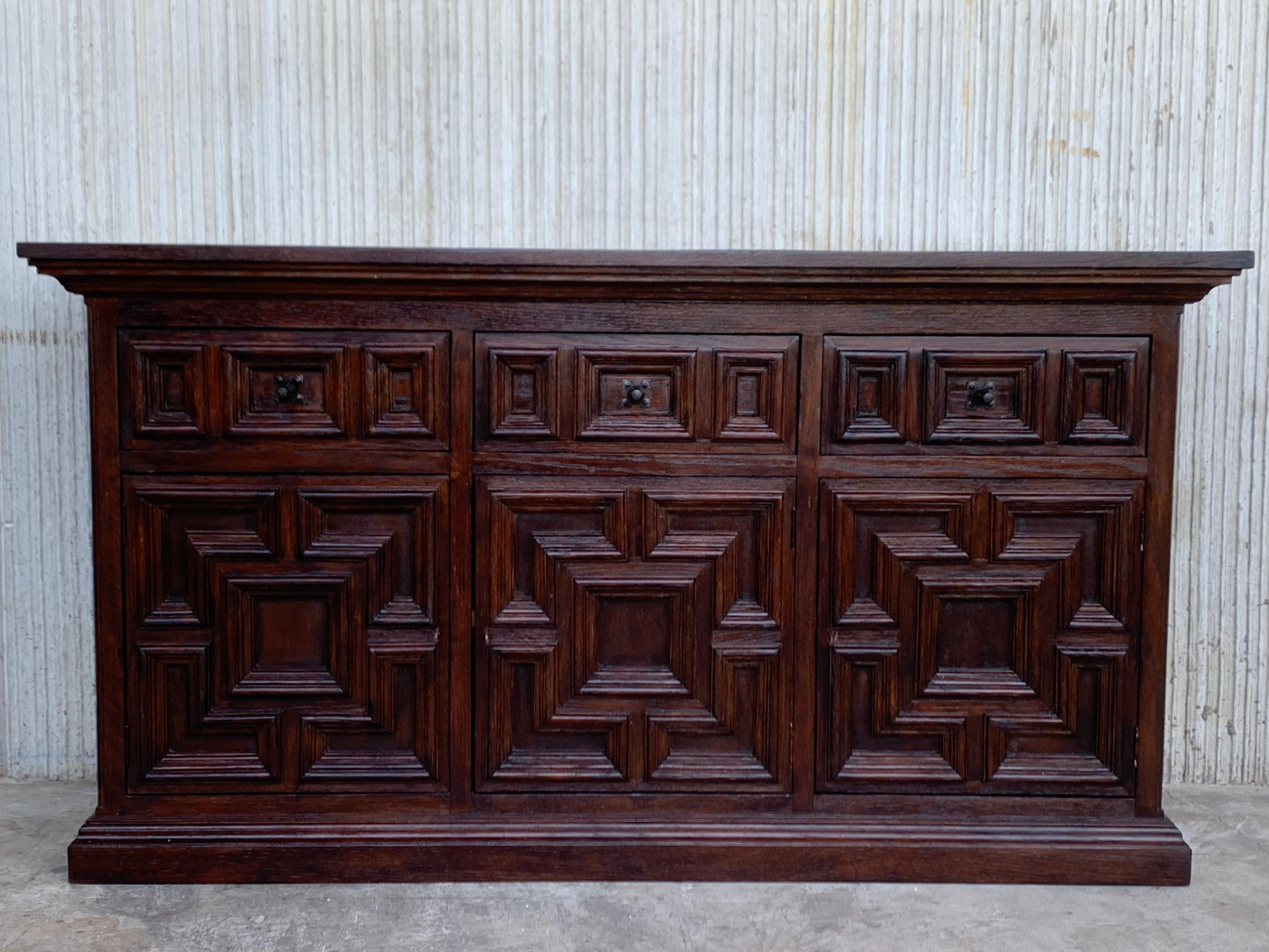 From Northern Spain, constructed of solid oak, the rectangular top with molded edge atop a conforming case housing two drawers over two doors, the doors paneled with solid oak, raised on a plinth base.
Very heavy and original cabinet.
 