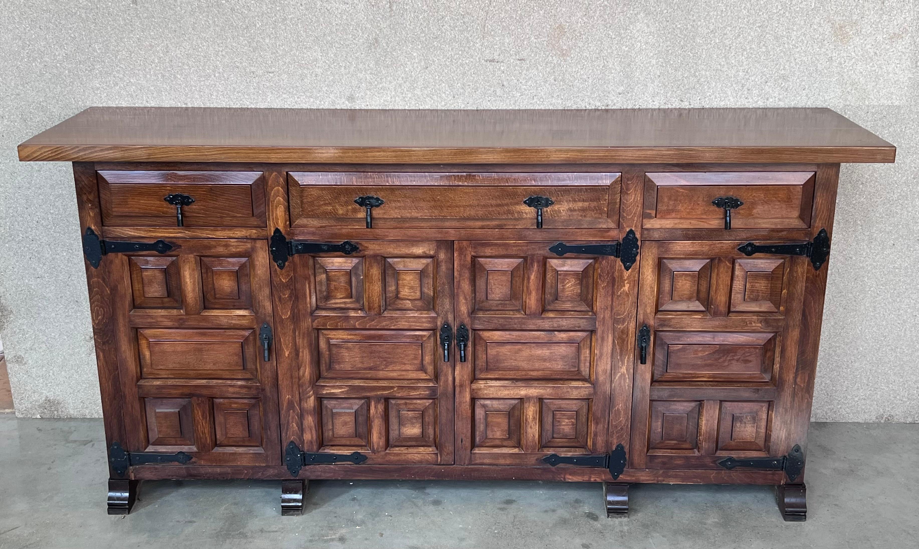 From Northern Spain, constructed of solid oak, the rectangular top with molded edge atop a conforming case housing three drawers over four doors, the doors paneled with solid walnut, raised on a plinth base.
Very heavy and original cabinet.
    