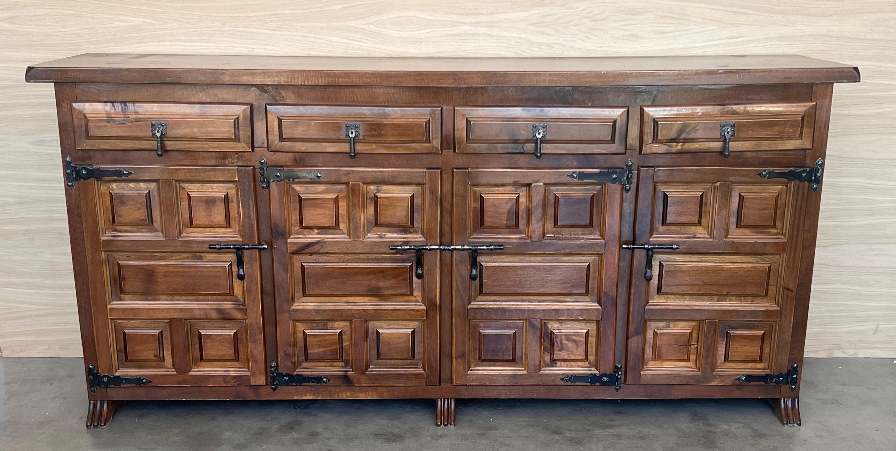 From Northern Spain, constructed of solid oak, the rectangular top with molded edge atop a conforming case housing four drawers over four doors, the doors paneled with solid walnut, raised on a plinth base.
Very heavy and original cabinet.
    