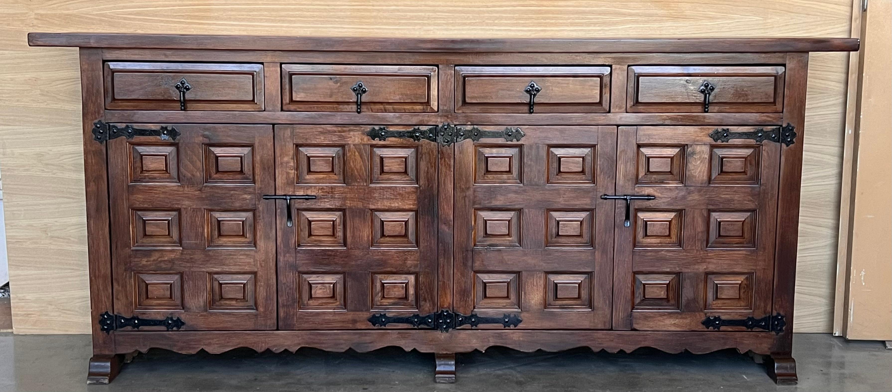 From Northern Spain, constructed of solid oak, the rectangular top with molded edge atop a conforming case housing three drawers over three doors, the doors paneled with solid walnut, raised on a plinth base.
Very heavy and original cabinet.
    