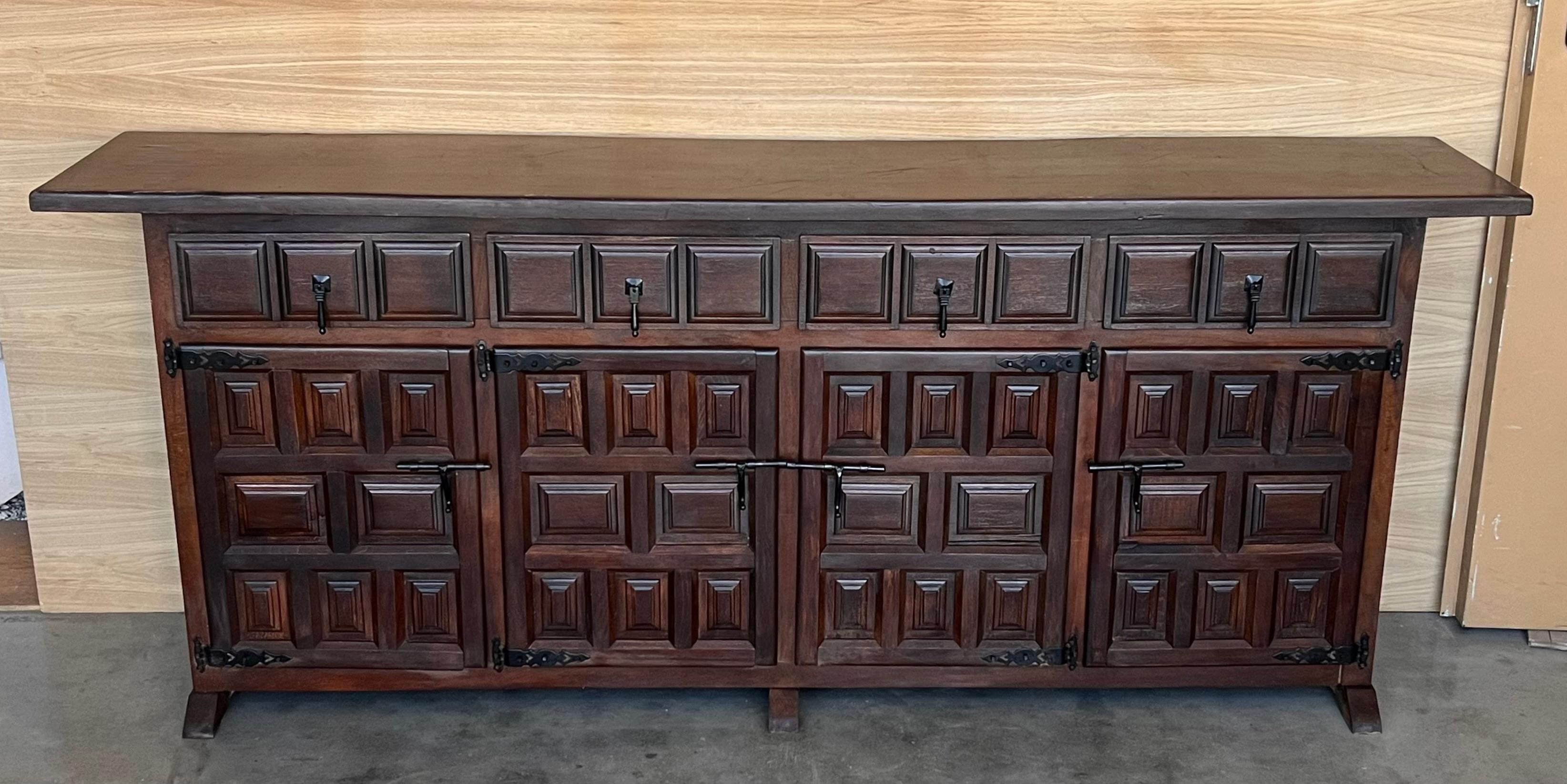 From Northern Spain, constructed of solid walnut, the rectangular top with molded edge atop a conforming case housing four drawers over four doors, the doors paneled with solid walnut, raised on a plinth base.
Very heavy and original cabinet.
    