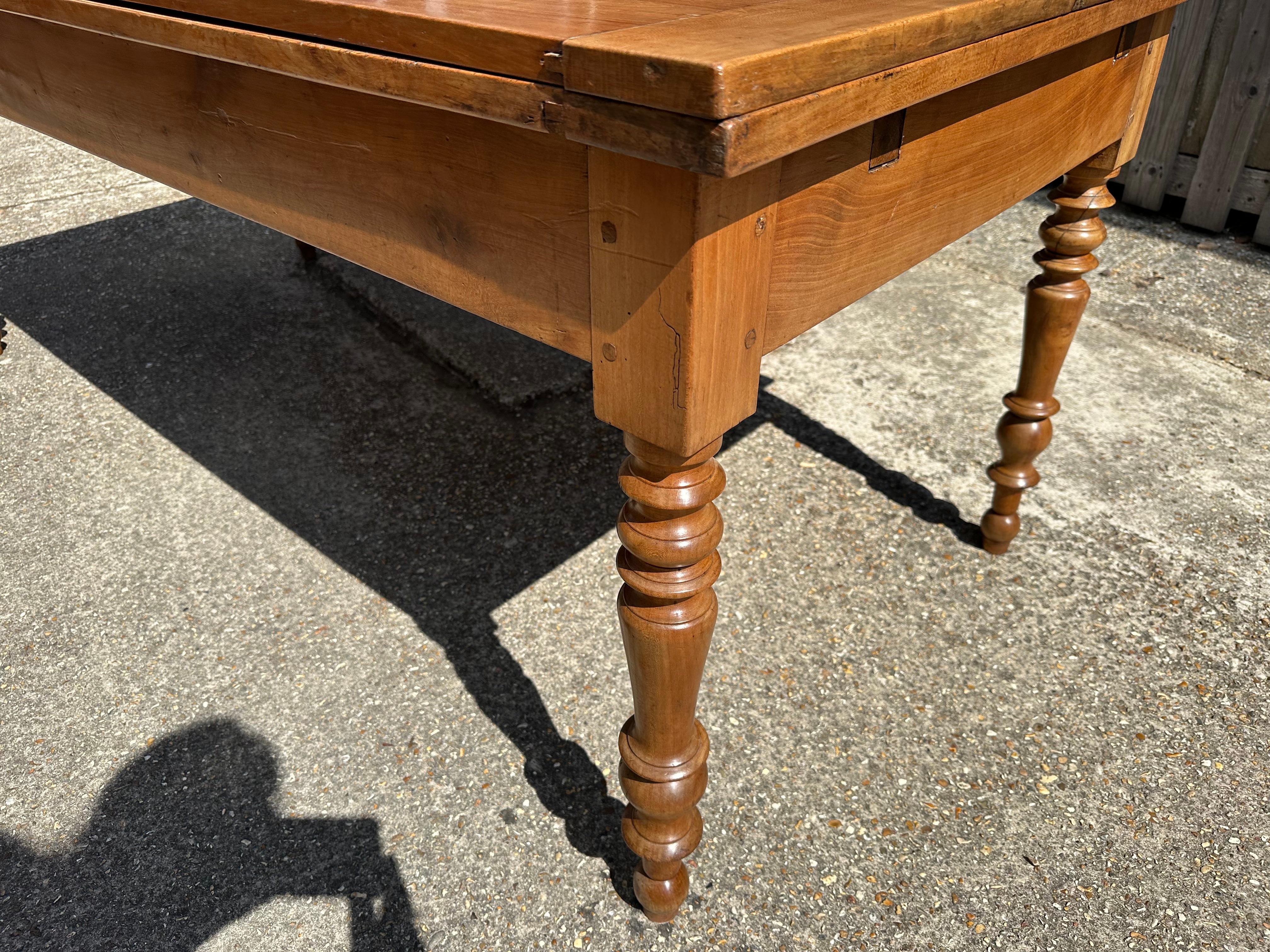 19th Century Cherry Dining Double Extending Table with one side drawer. The table sits on sturdy base with round legs. The table has stunning patination and colour. This table is a fabulous size once open. (157