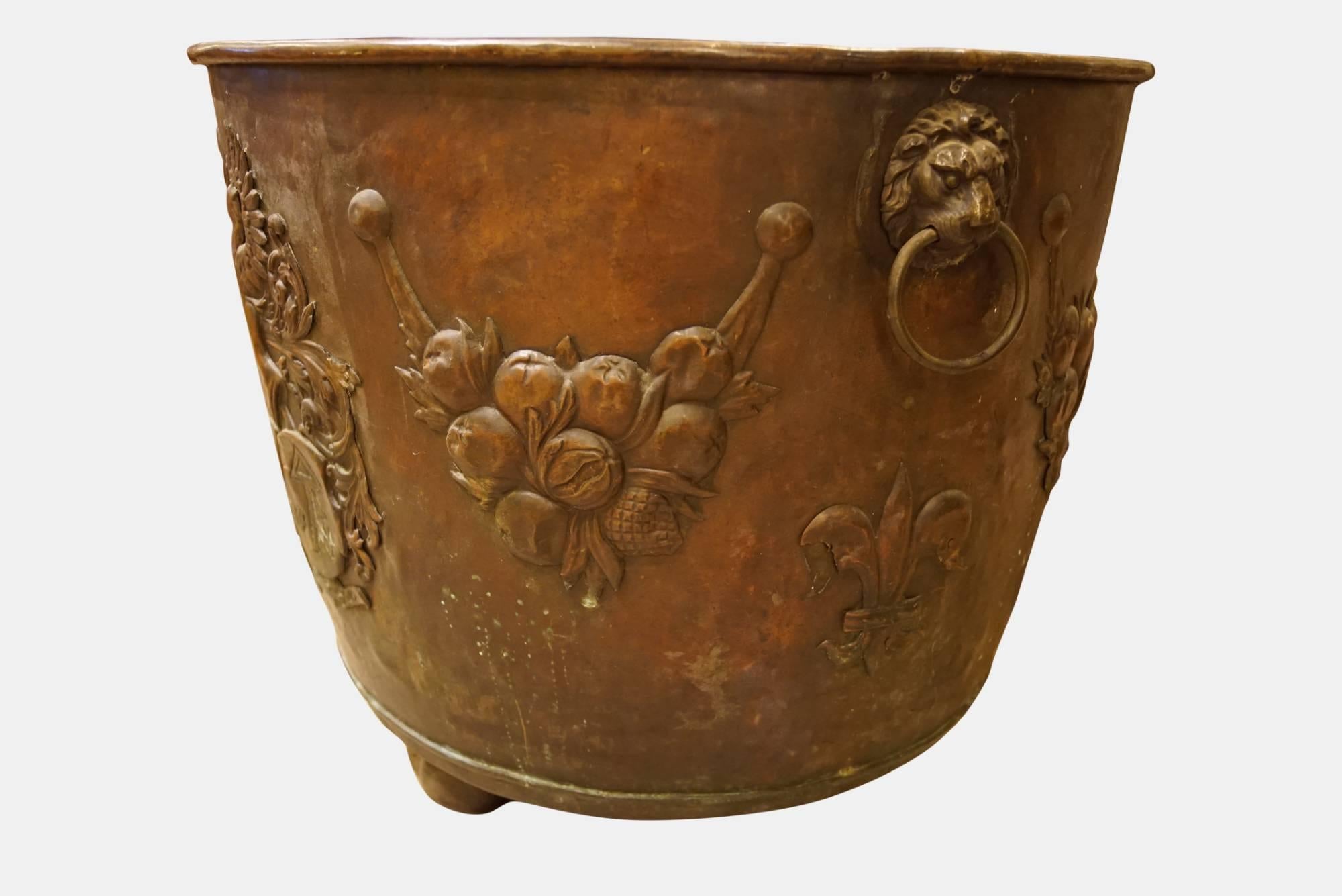 A large copper log bin with armorial decoration,

circa 1890.