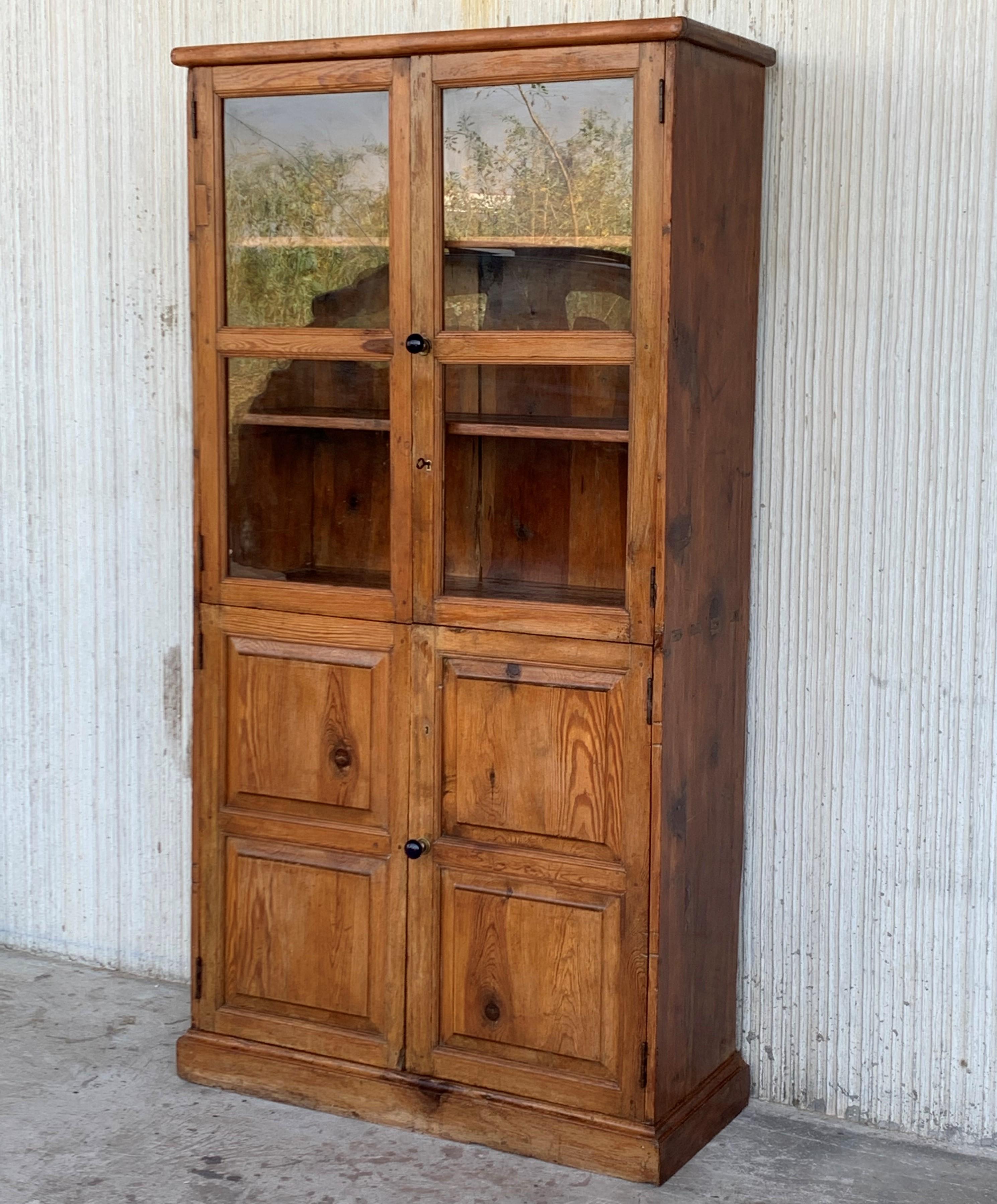 19th century Spanish cupboard or bookcase with glass vitrine, constructed from a pine called 