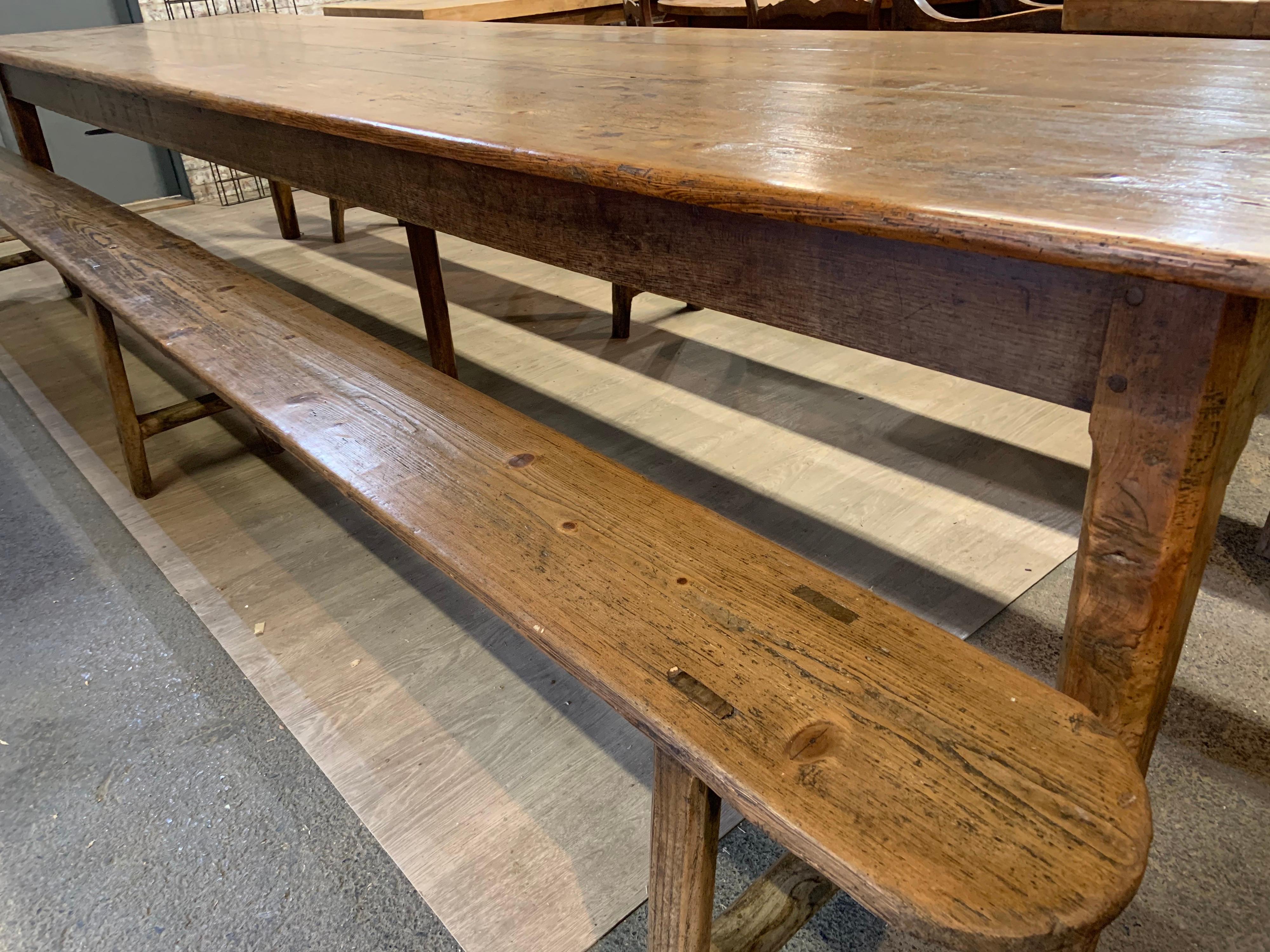 19th century large farmhouse table with two long, wide benches. The table has great width and length. The table sits on six square tapering legs. The table has a wonderful four plank top with glorious colour and patination. The table has good