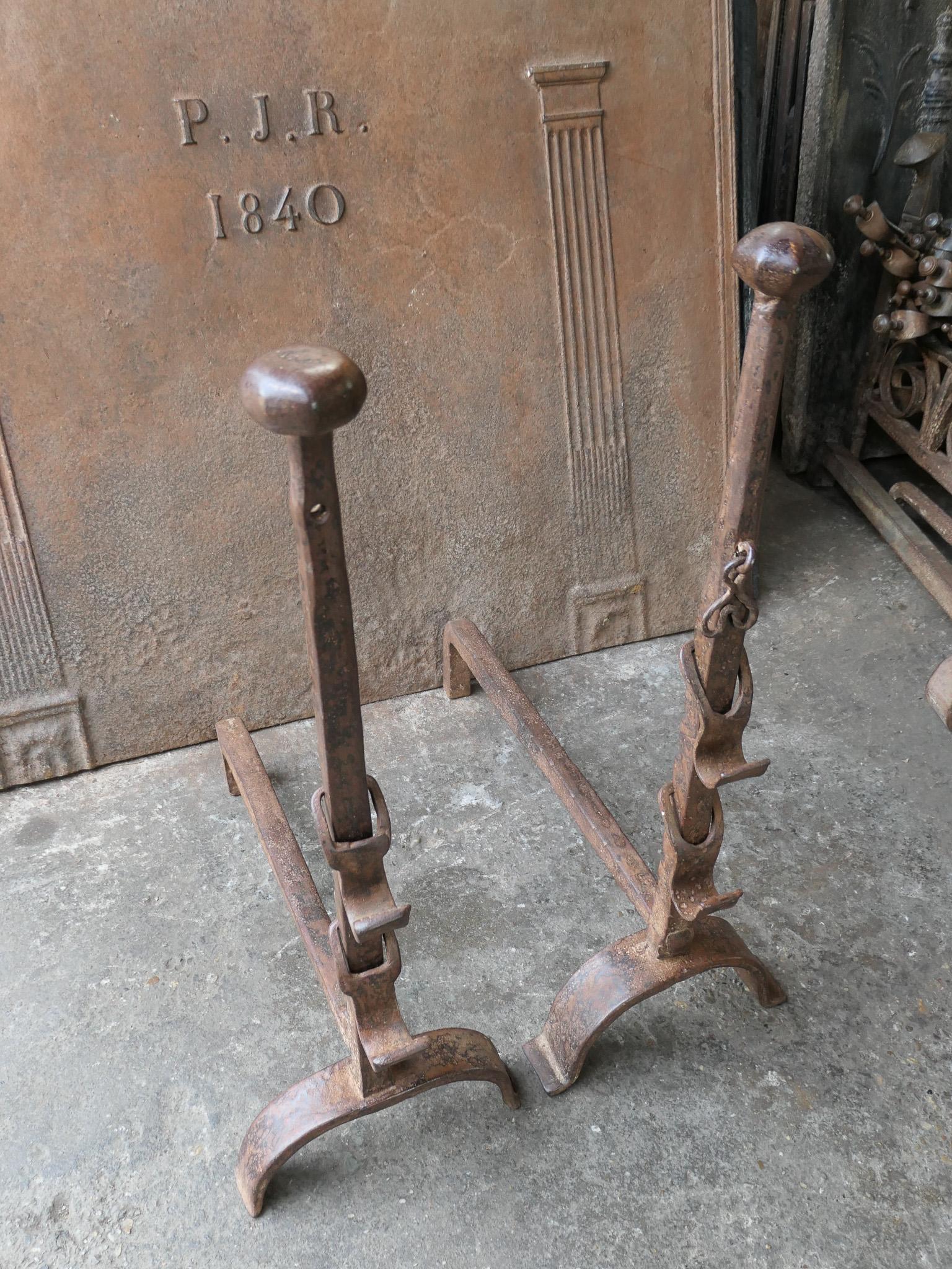 19th century French Louis XV period andirons / fire dogs made of wrought iron. These French andirons are called 'landiers' in France. This dates from the times the andirons were the main cooking equipment in the house. They had spit hooks to grill