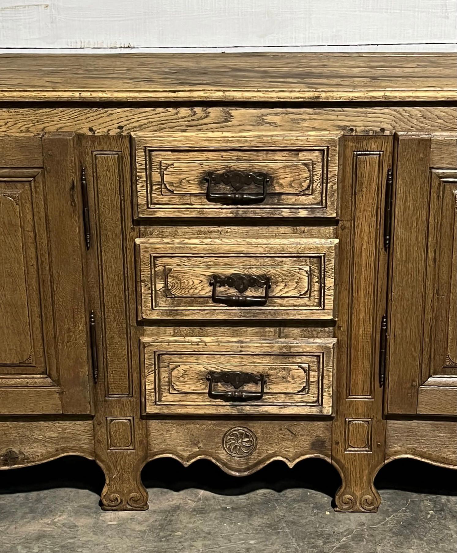 A stunning French oak sideboard, enfilade or dresser base. Dating from the mid to late 19th Century and classic French pretty style. We have bleached it to bring out the natural beauty of the wood. Keys are present to locks and drawers run smoothly,
