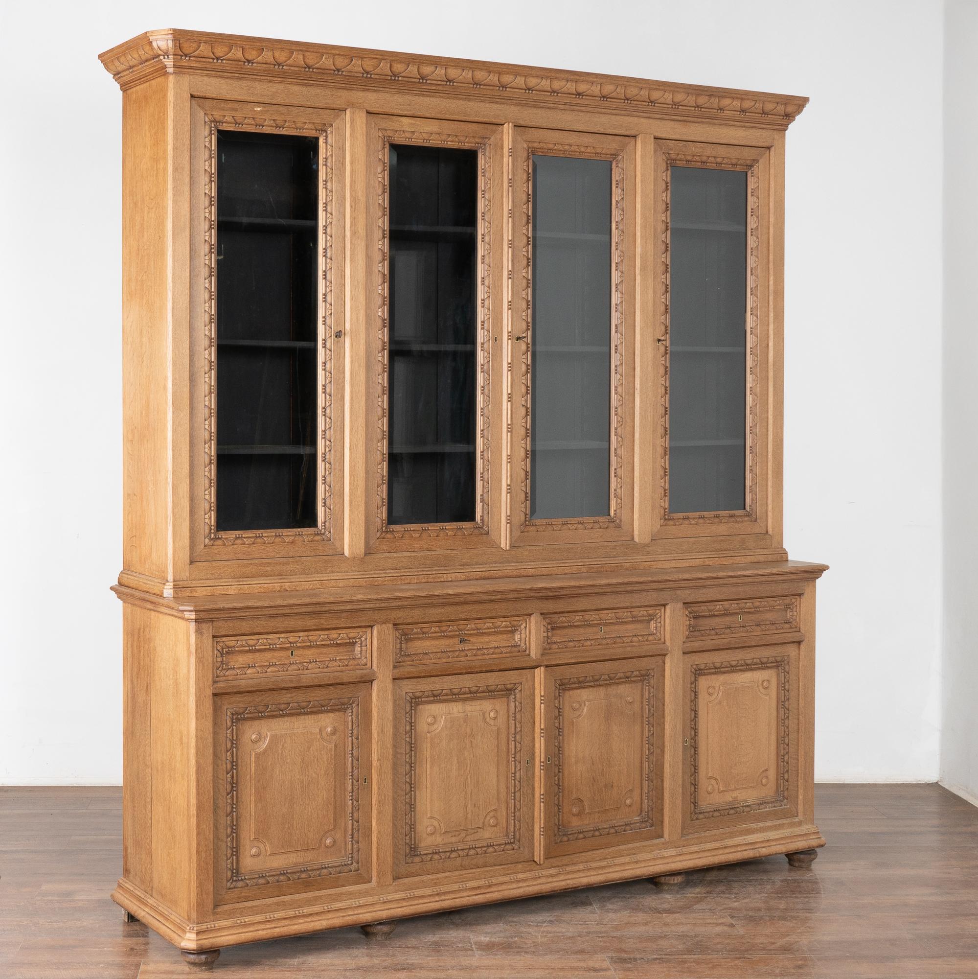 This impressive oak display cabinet has four upper cabinet doors and four lower drawers and panel cabinet doors.
Items displayed in upper cabinet are easily viewed through the glass doors which adds to the French country feel of this 7.5' wide and