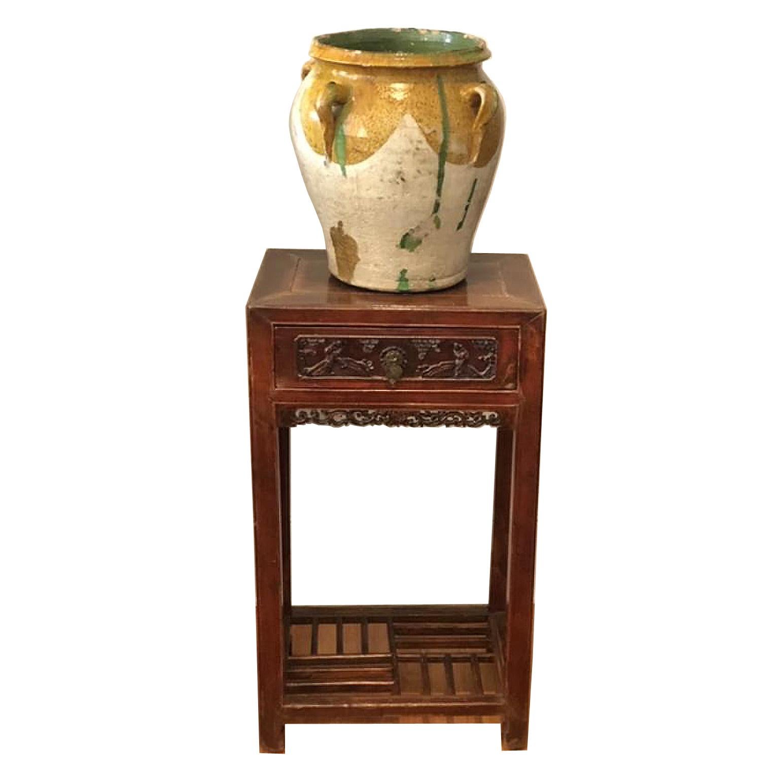 A very beautiful and large terracotta pot or urn with white under-glazing and mustard yellow and green over-glazing, with four handles, France, circa 1800s. The lovely patina that shows wear and use, gained over its long history, is this urn's most