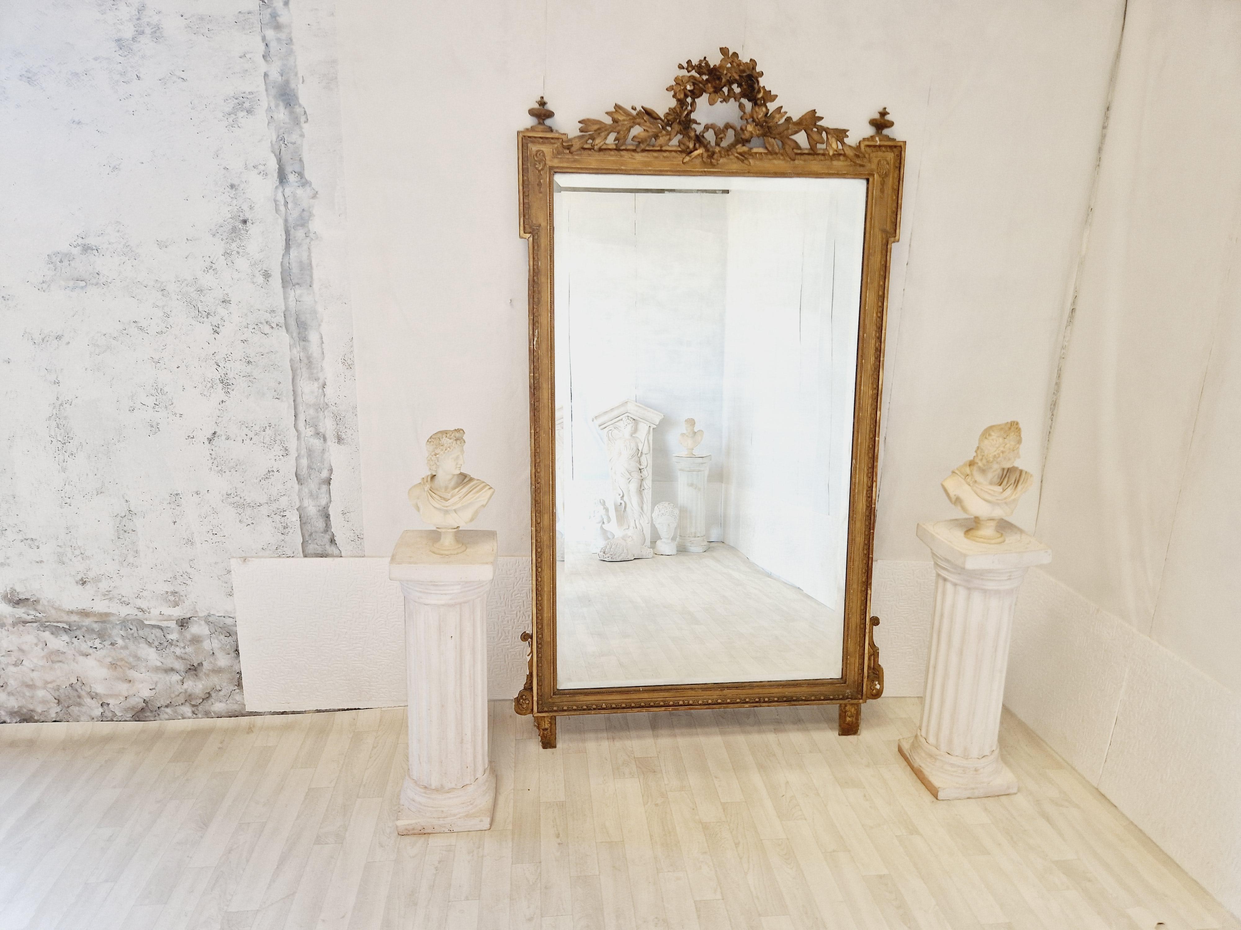 Add a touch of Antique aesthetics and history to your home with this Giltwood framed Louis XVI Style wall/Floor mirror. The rectangular mirror has a height of 200 cm and a width of 107 cm, with a beautiful detailing of Flowers and Acanthus. The