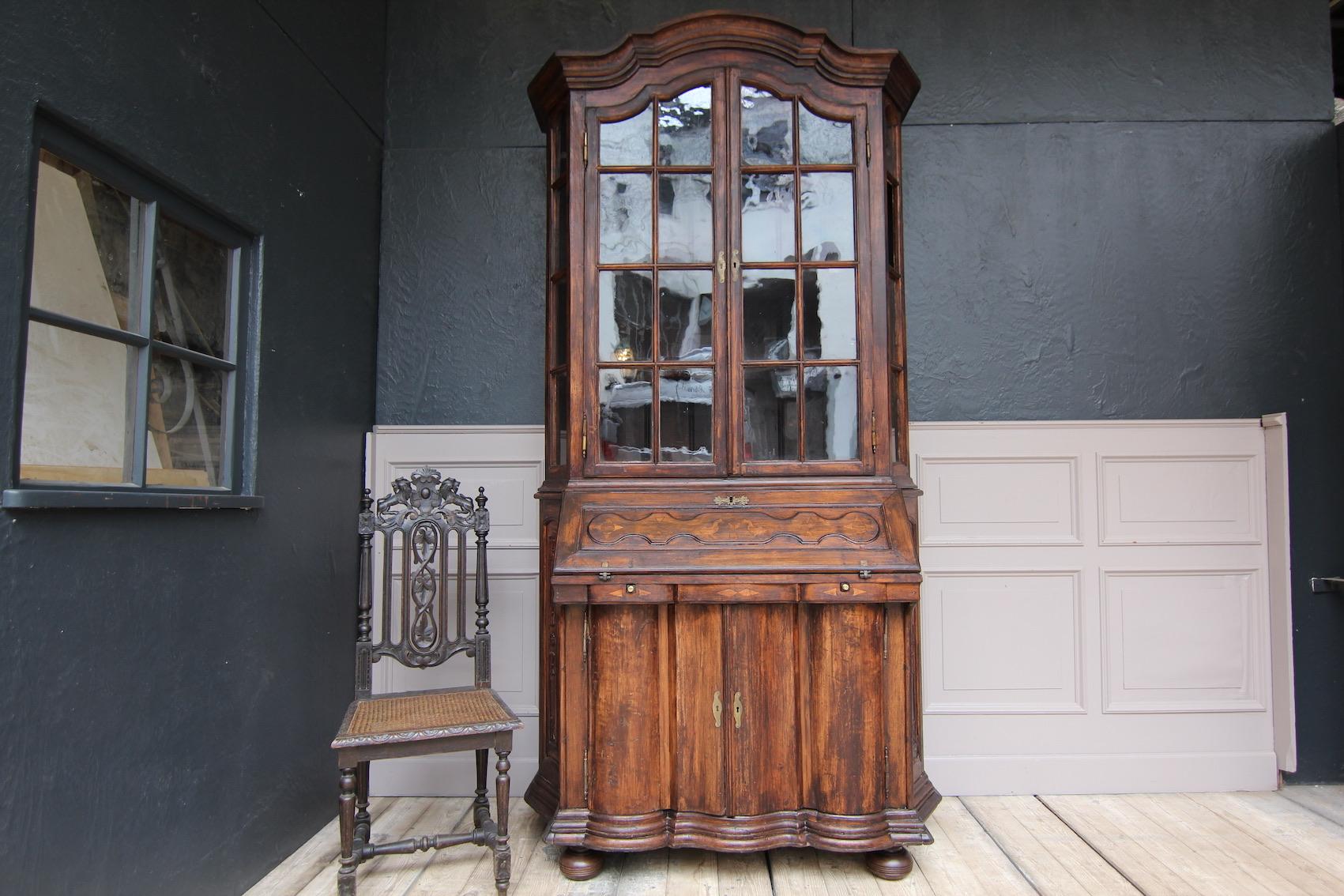 Large German Provincial Baroque secretary a Deux corps from the Eifel region. Probably a one-off production from the 19th century.
Solidly handcrafted from different types of wood (including maple and oak) with inlay work and carving.
Standing on 4