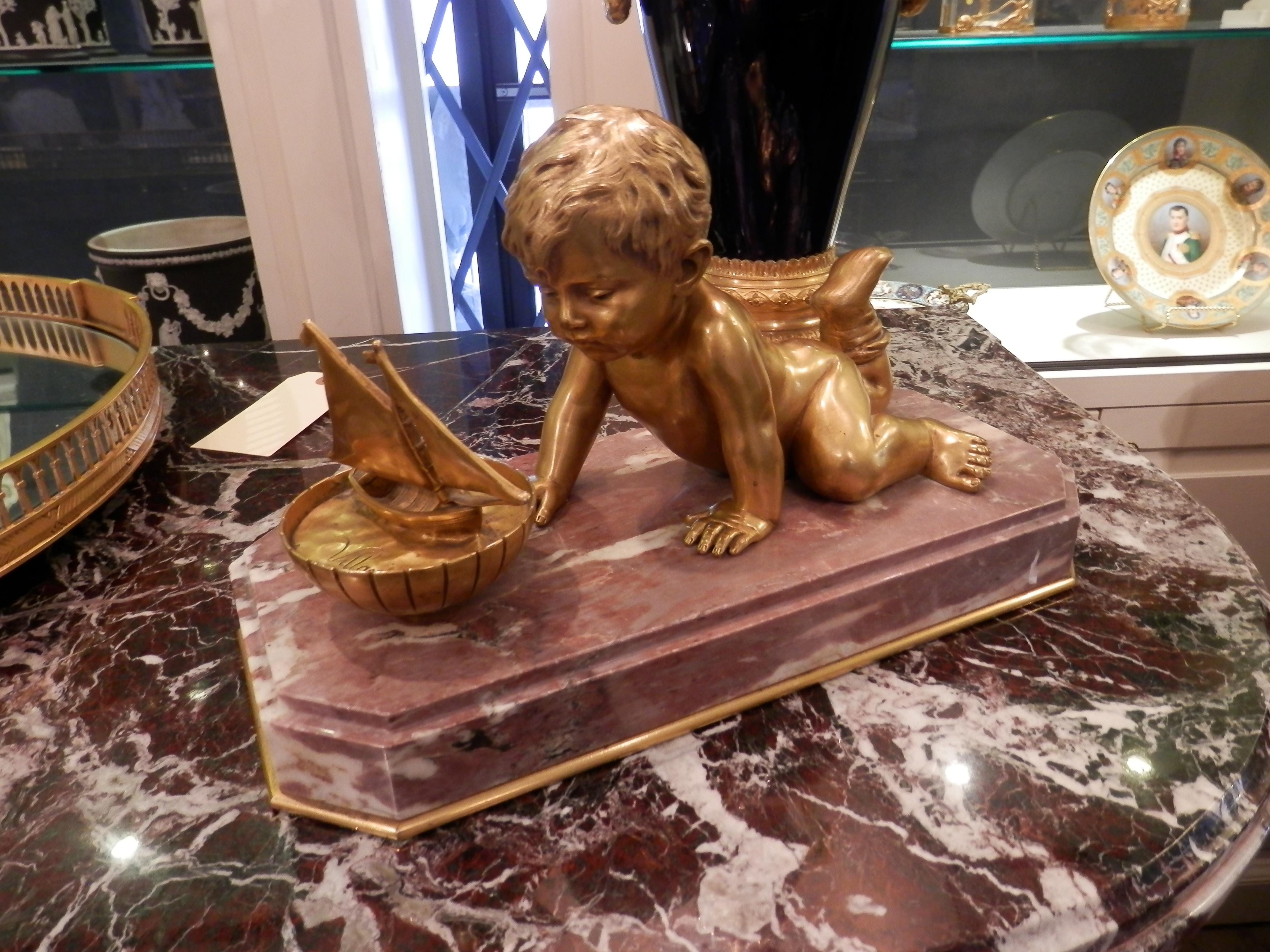 19th century large and fine gilt bronze centerpiece. Signed by the artist. Depicting a gilt bronze cherub playing with his toy boat. Finely cast and chased on a marble base.
