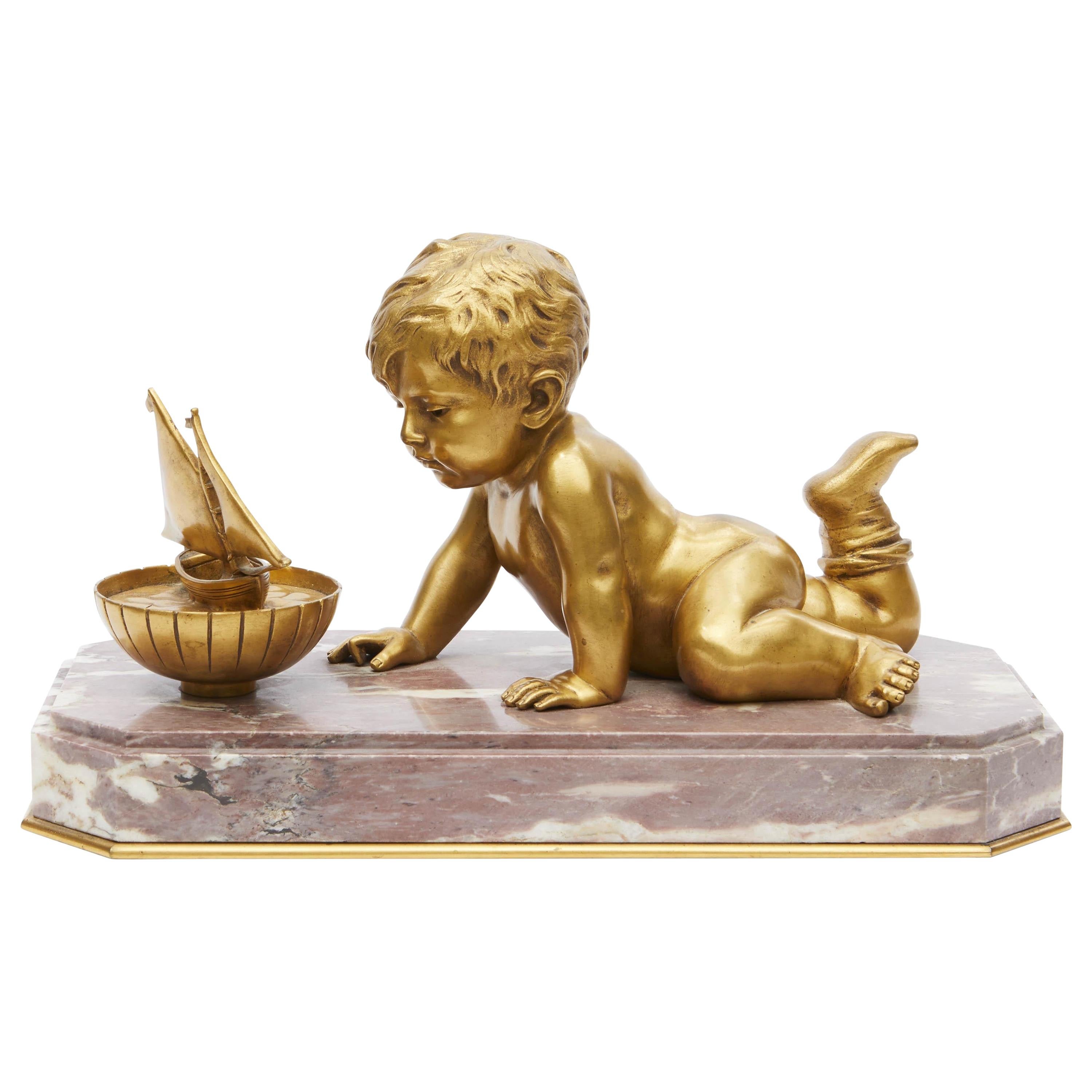 19th Century Large Gilt Bronze Cherub Playing with His Toy Boat on a Marble Base For Sale