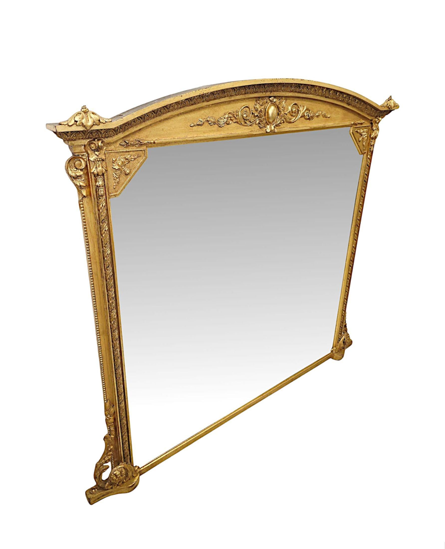 A fabulous 19th Century giltwood overmantel mirror of grand proportions with original glass and back, finely hand carved and of exceptional quality.   The mirror glass plate of shaped, rectangular form is set within a gorgeous moulded and fluted