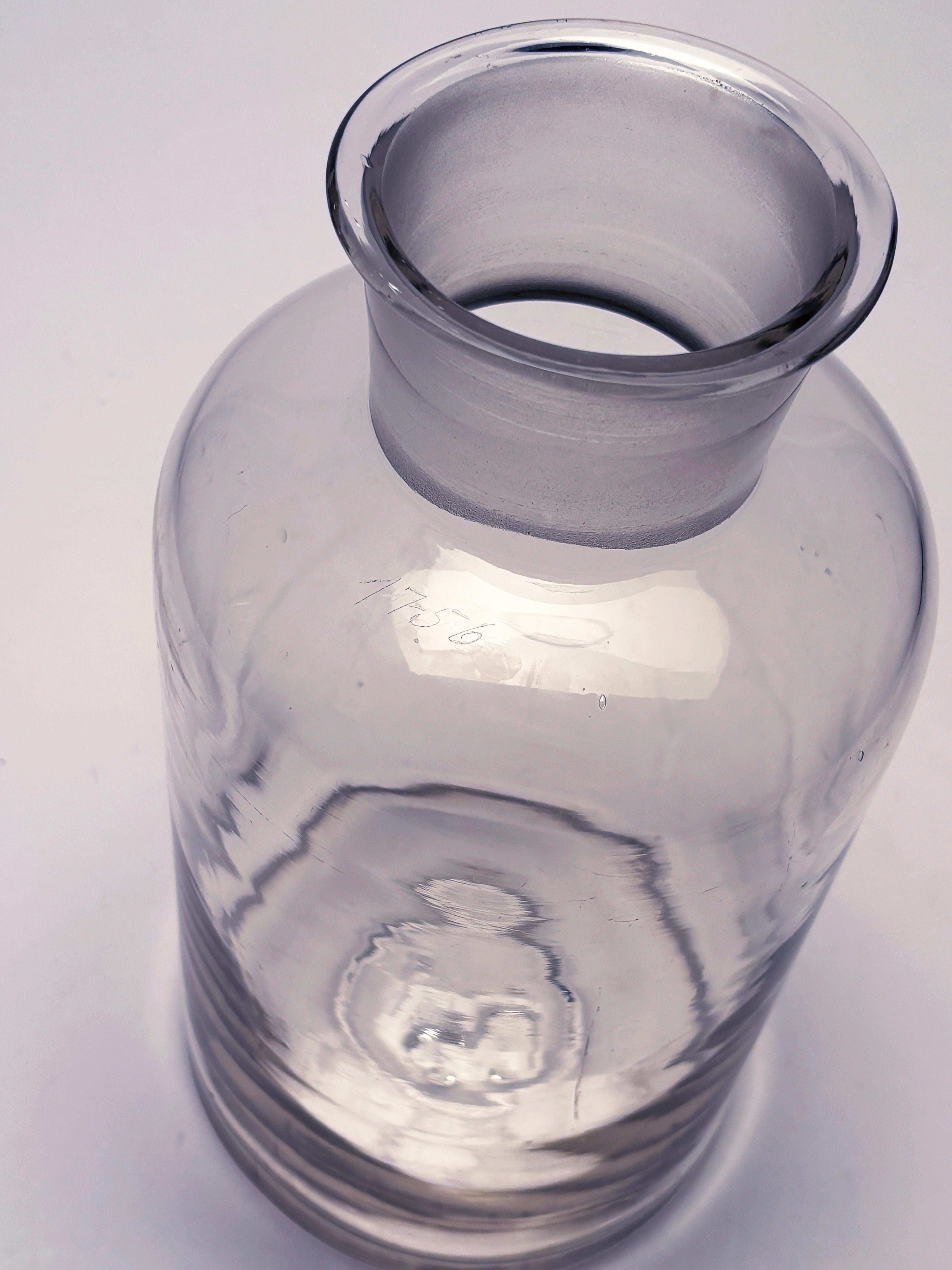 As far as apothecary pieces prior to 1930's go, this one is one of the more unique of the era.  The extra large size, perfectly fitted glass stopper and interesting imperfections in the hand-blown glass add to the appeal, but what makes it most