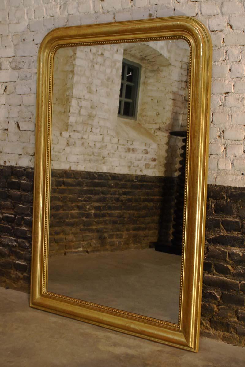 A handsome large Louis Phillipe mirror that originates in Southern France and was made circa 1870. It has the upper rounded corners that are typical for a Louis Philippe style mirror. The mirror frame is made in solid pine and was smoothened with