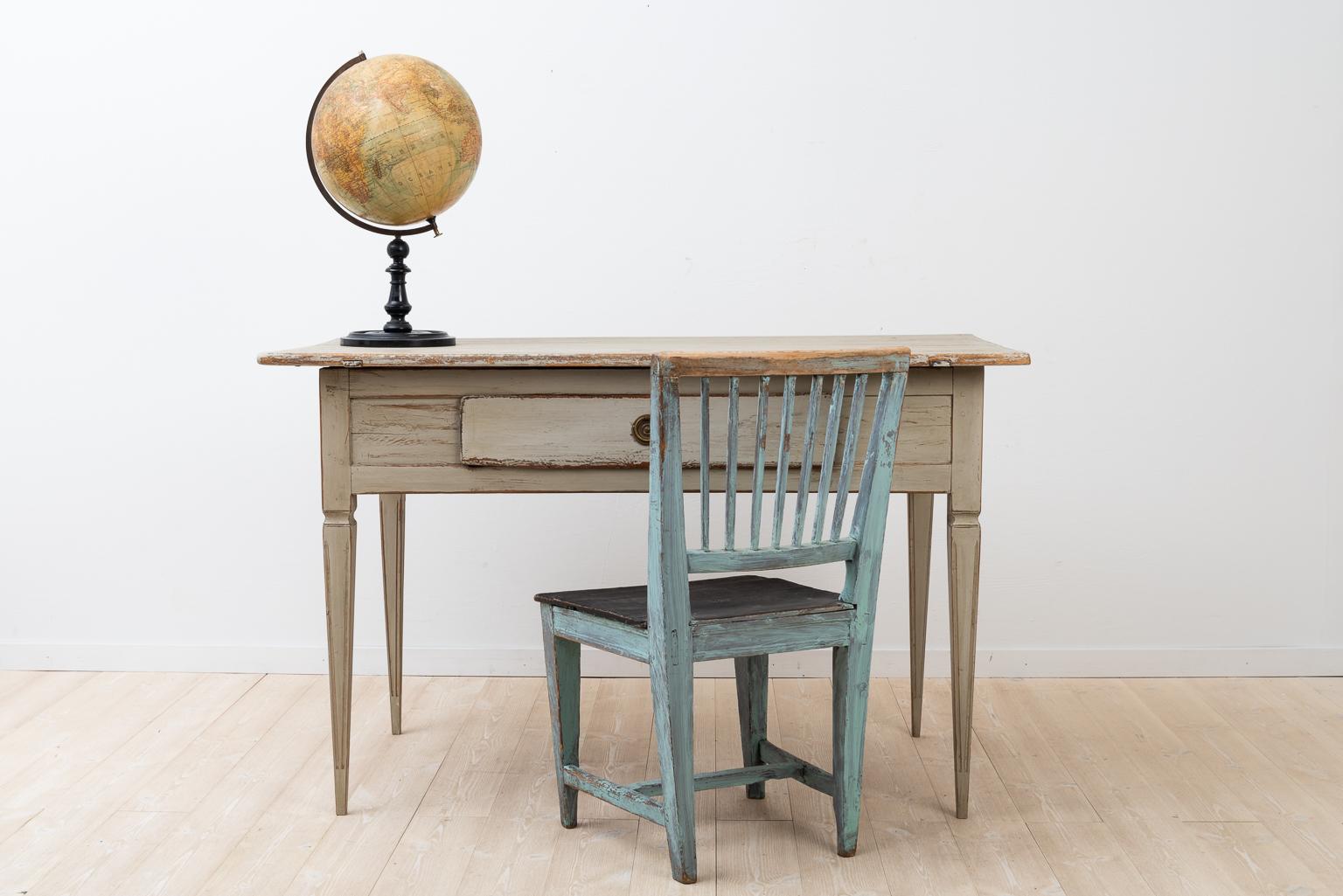 Large Gustavian styled writing table. The table has one centered drawer. The legs are straight and tapered with a fluted design. Manufactured during the early 19th century. Height from the floor to the underside is 61 cm.