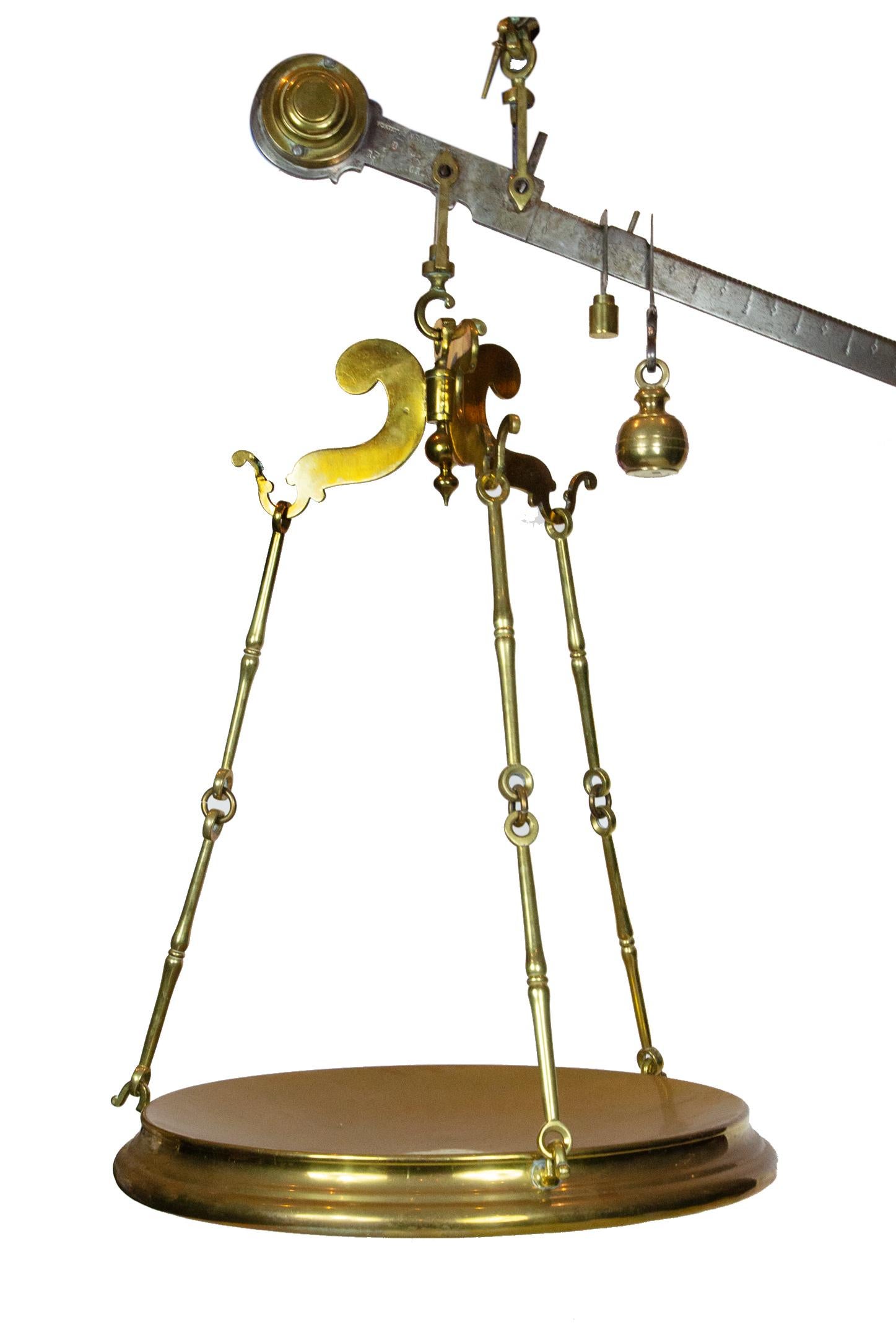 19th century large Italian brass butcher's scale.

An Italian brass hanging butcher's scale from the 19th century. This Italian scale features a horizontal beam with weight sat the end. The upper beam will hang from the ceiling or perhaps an