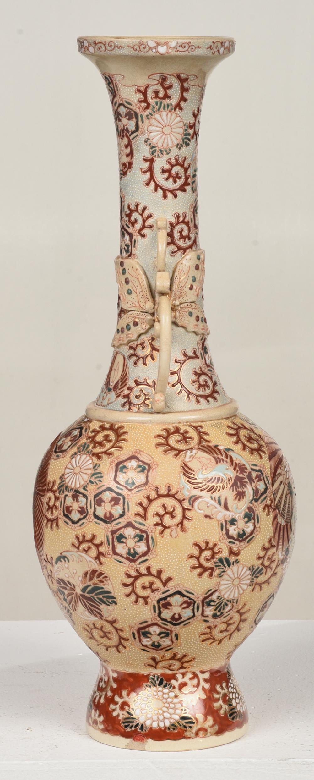 Meiji period, bottle form with tall flared neck and scrolls handles, polychrome moriage enamel and gilt decoration, decorated with dragon and phoenix on each side, with chrysanthemums, scrolls, and floral roundels throughout.

A small professional