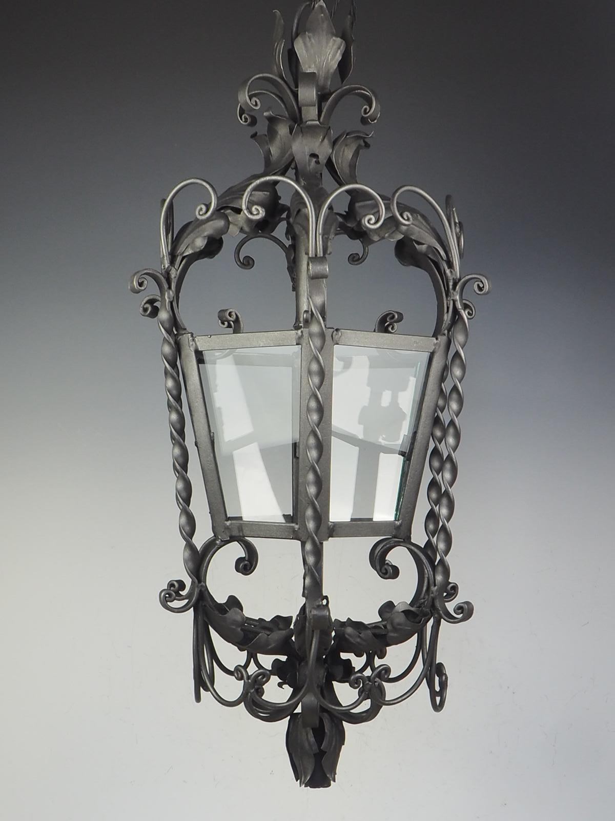 19th Century Large Ornate French Wrought Iron Lantern

A magnificent oversized French antique ceiling single-light lantern, open-framed tapering hexagonal shape, ornately decorated with leafy foliage and scrolls.