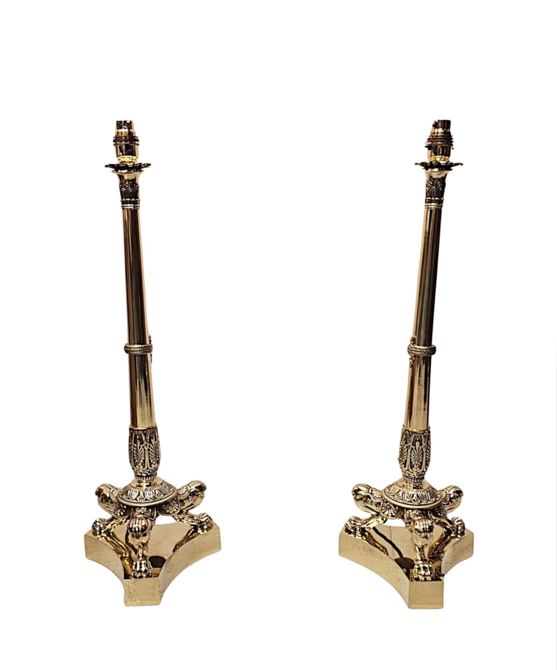 A fabulous pair of 19th Century Empire Style finely cast brass candlesticks of grand proportions, fully restored and converted to table lamps with beautiful patination and of exceptional quality.  The elegantly reverse tapering ring turned columnar