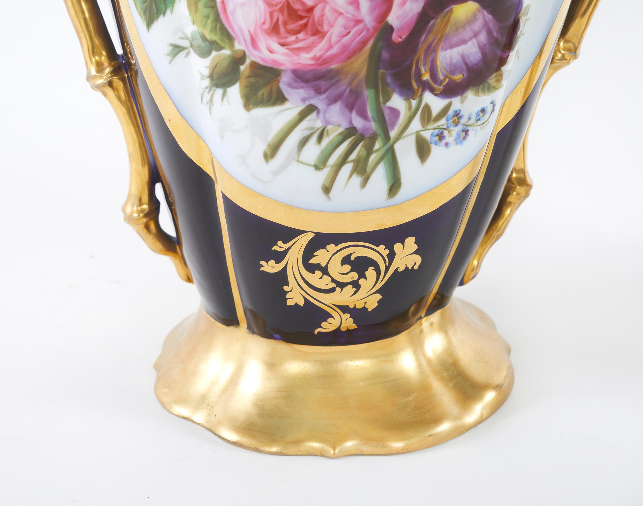 Mid 19th century pair of Old Paris Porcelain decorative vases / urns with exterior gilt gold painted design detail scenes. Each vase featuring two gilt handles and painted scenes of figures in a garden court setting. Each vase is in great condition.