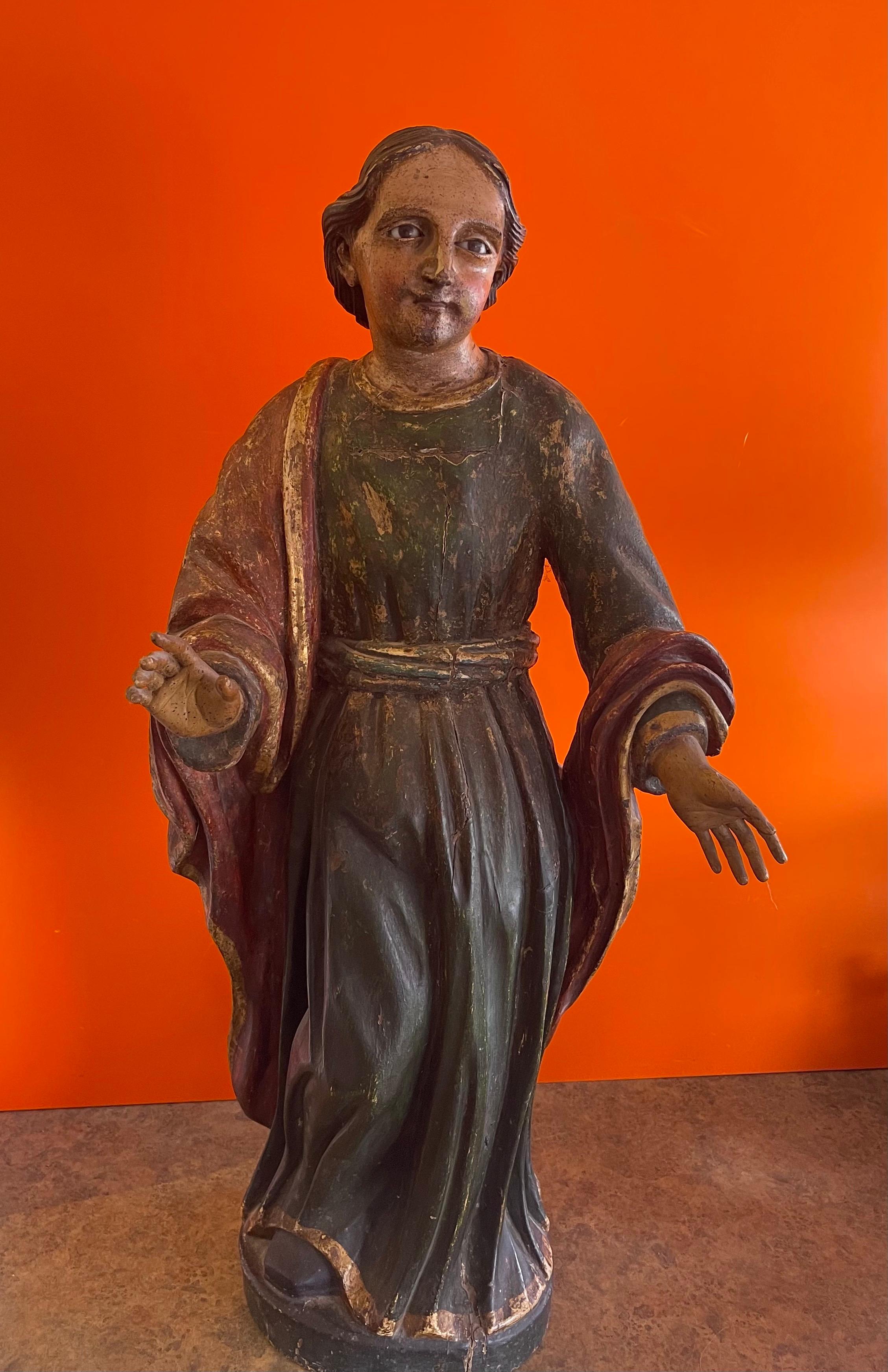 Stunning large polychrome Santos carving from Spain, circa 1800s. The piece is hand carved in a soft wood with original paint, polychrome finish and glass eyes. The piece is in remarkable condition for its age with all fingers and details intact; it