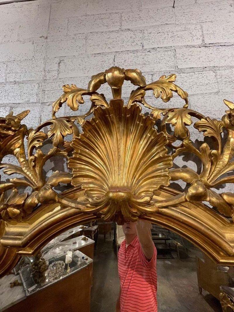 Exceptional 19th century large scale French Rococo carved giltwood mirror. Impressive carvings including an ornate crest. There is a cherub that can be added to the center of the crest but the mirror also looks complete without it. Lovely either