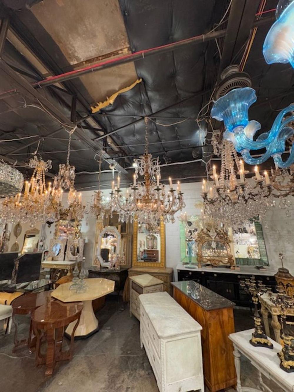 The 19th Century Large Scale Italian Basket Form Crystal Chandelier is a grand and ornate lighting fixture designed in a chandelier style. This chandelier is characterized by its large size and intricate basket form, featuring an abundance of