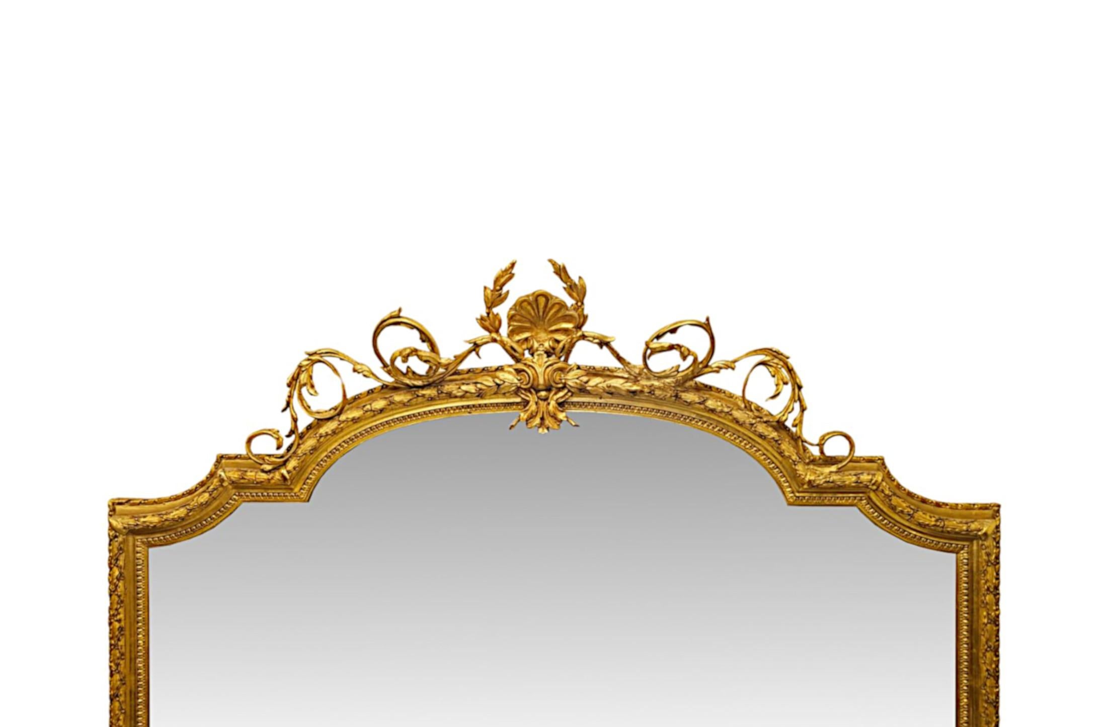 A very rare 19th Century giltwood overmantel mirror of exceptional quality and grand proportions.  The shaped mirror glass plate is set within an elegantly simple and finely hand carved moulded, pierced and fluted giltwood frame with fabulous