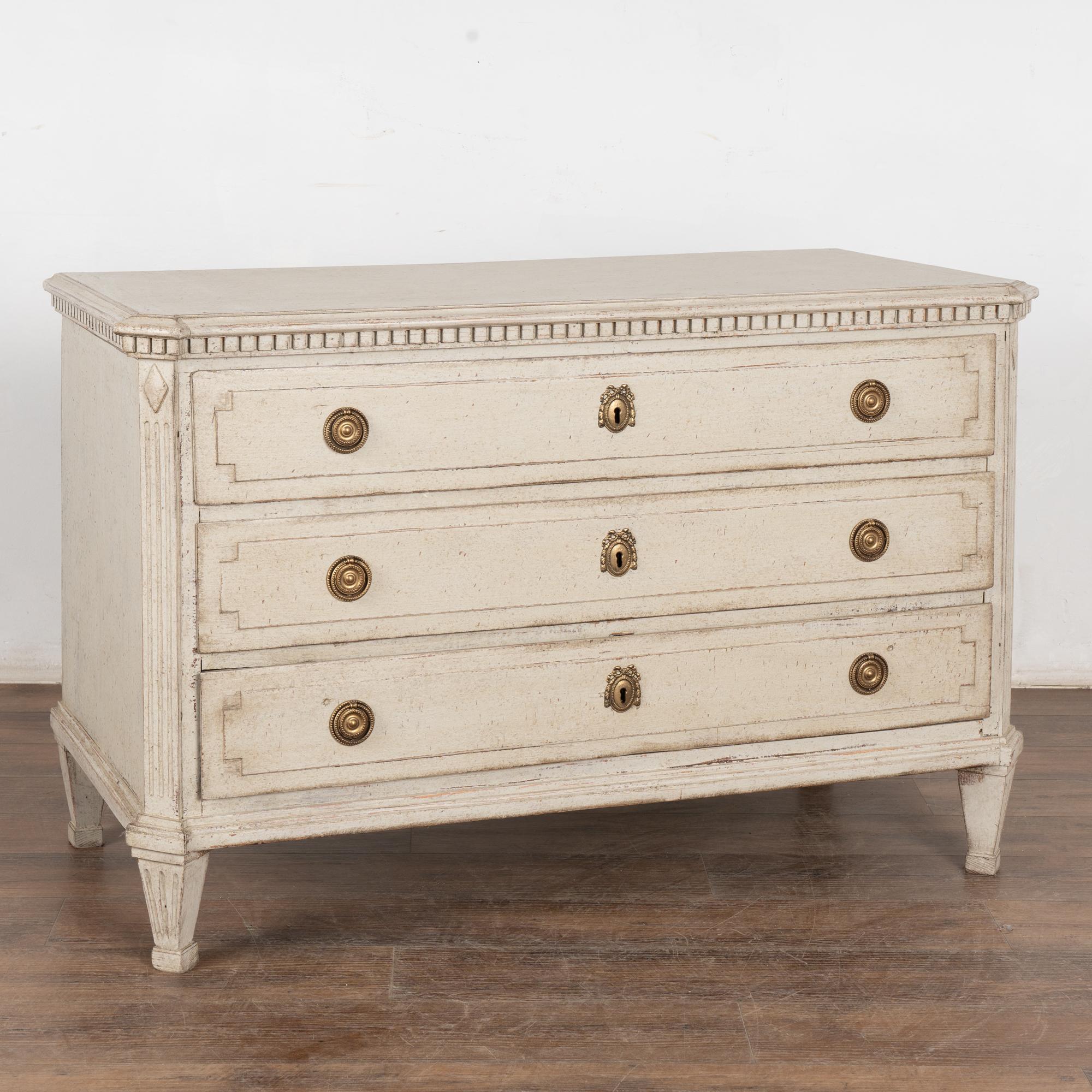 This lovely Gustavian style pine chest of drawers has the simple yet elegant lines that reveal its Swedish country style. This hard to find size is large at 4' wide.
The carved dentil molding along top, canted fluted side details and gently tapered