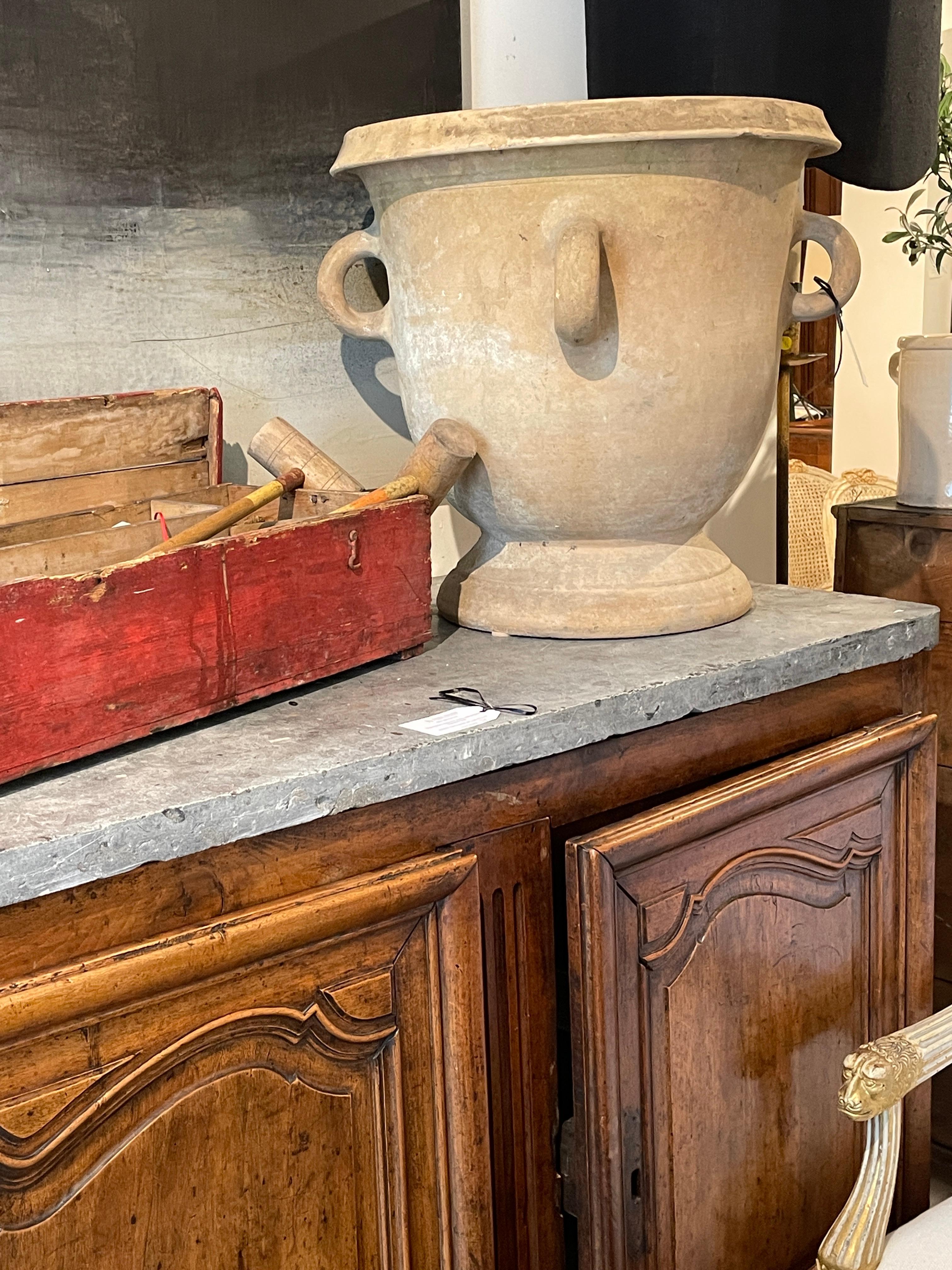 This impressive 19th-century large terra cotta jardiniere hails from Castelnaudary, a region renowned for its exceptional pottery. The jardiniere boasts a grand, classical shape with a wide, flared rim and a substantial base that provides stability