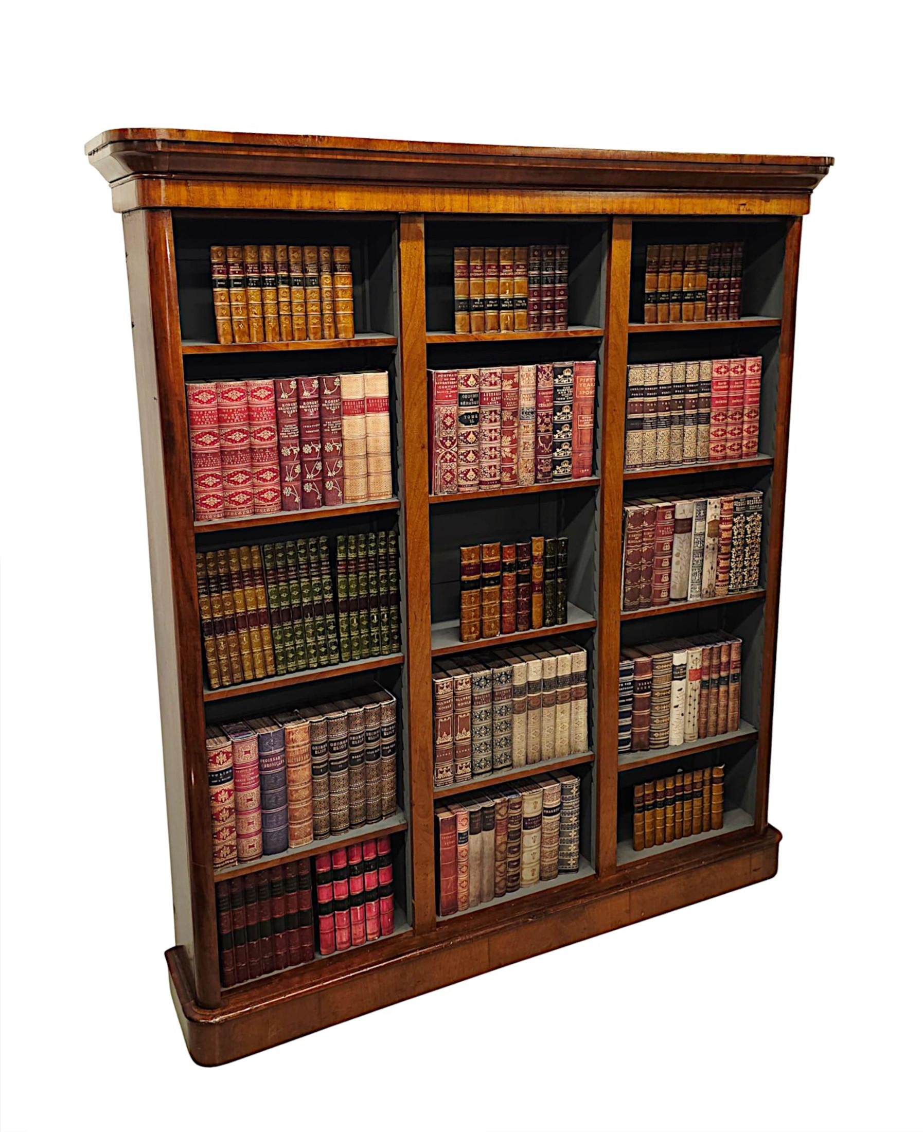 A fabulous 19th Century well figured mahogany three section open bookcase of grand proportions, finely hand carved with beautifully rich patination and fine grain.  The moulded and stepped cavetto pediment is raised over an elegantly simple frieze