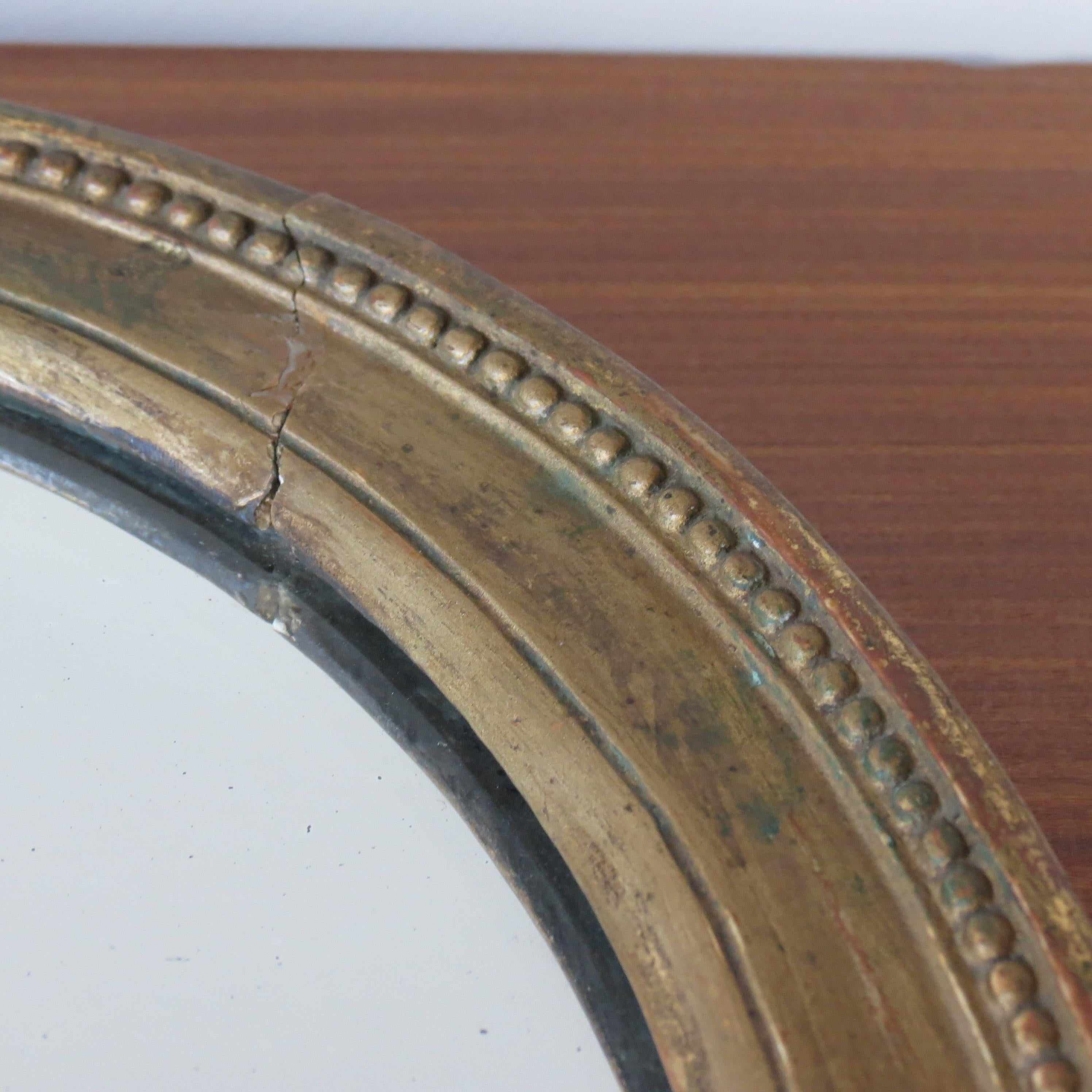 English 19th Century Late Georgian Oval Gilt Wall Mirror Circa 1830s