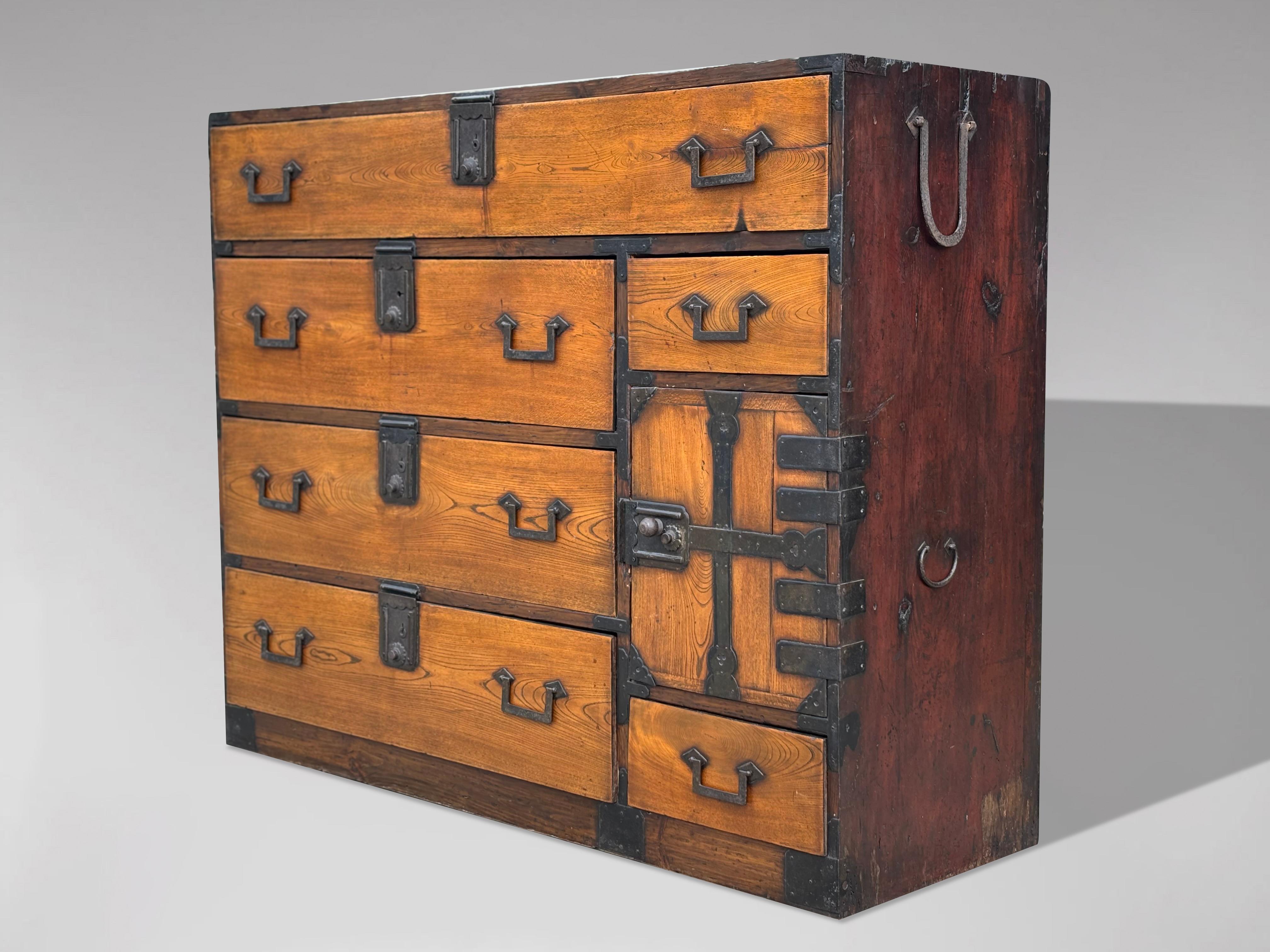 19th Century Late Meiji Japanese Keyaki Wood Merchant Tansu Chest

This stunning late 19th-century Japanese Meiji period tansu chest is a true masterpiece of craftsmanship. Crafted from exquisite keyaki (Japanese elm) wood in Sendai Prefecture, this
