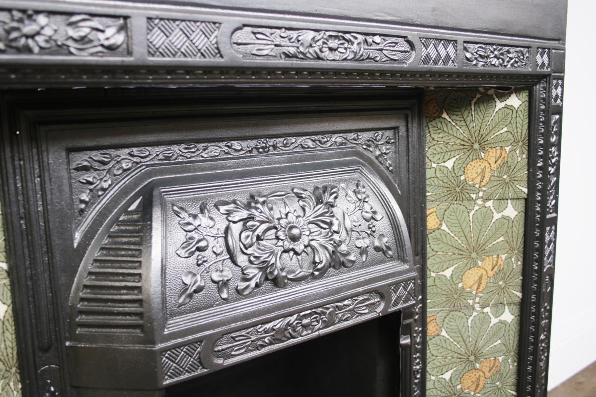 Reclaimed late Victorian cast iron fire insert. Dated 1886. Complete with a set of original fireplaces tiles.

This grate has been finished the traditional black grate polish, leaving a gun metal / pewter shine. Alternative finishes are available.
