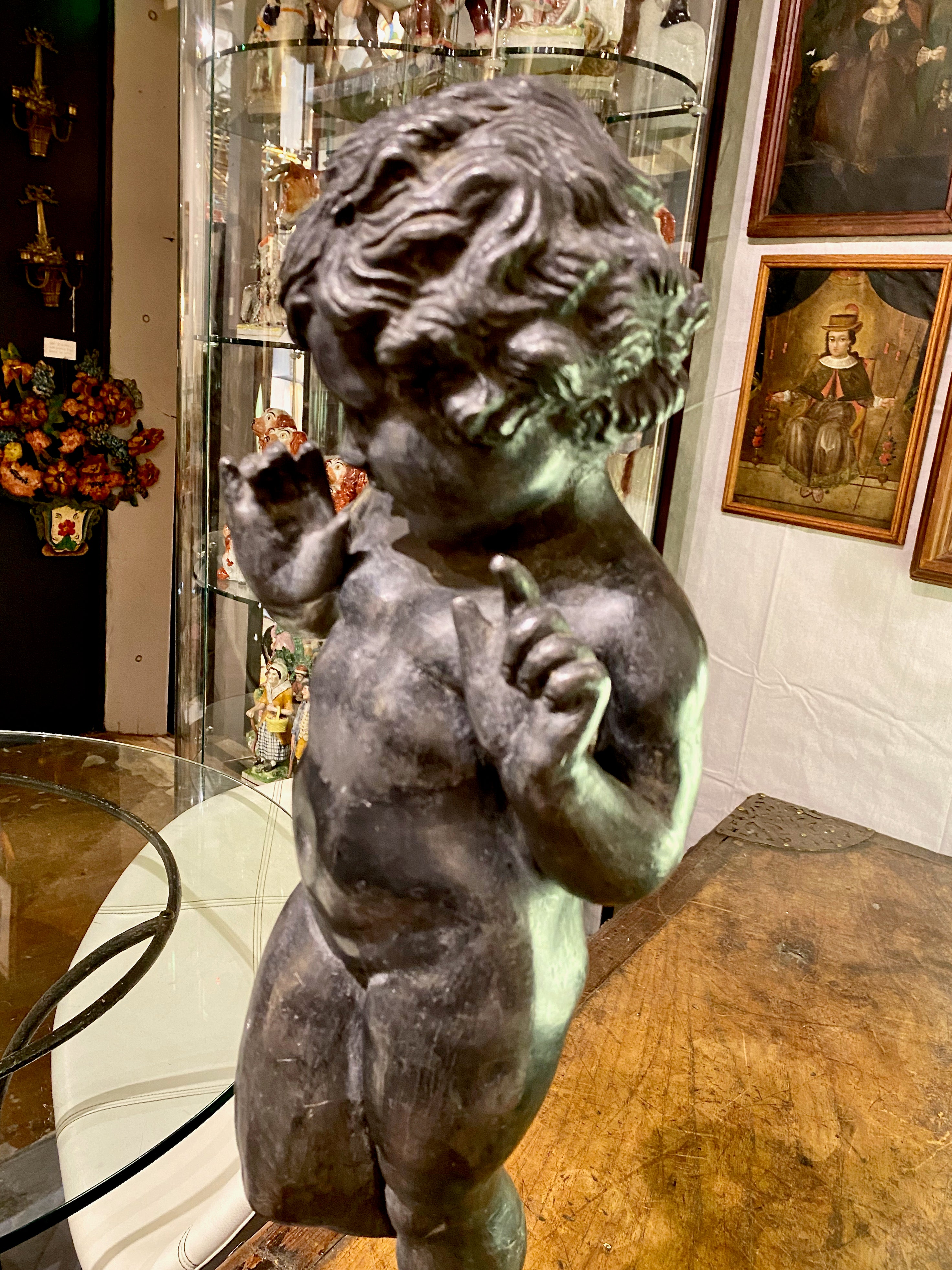 This is a wonderful example of a late 19th century English lead putti. These English lead figures were traditionally garden elements; but this example is in exceptionally good condition with just modest patination and could be placed just about