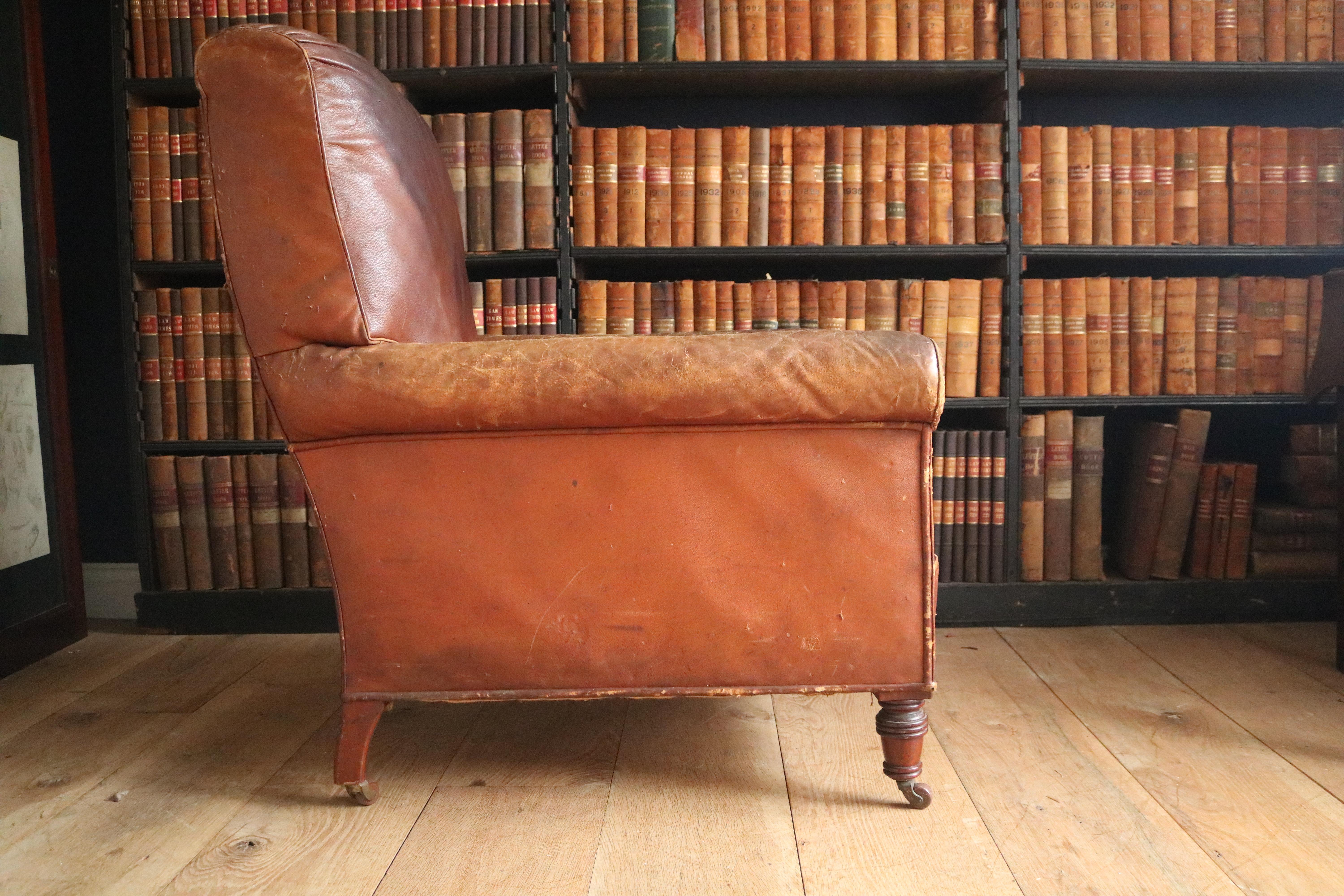 A fantastic 19th century leather armchair in a lovely London tan color, with a sack back and a down loose cushion. The chair is in remarkably good condition for its age and incredibly comfortable.
         