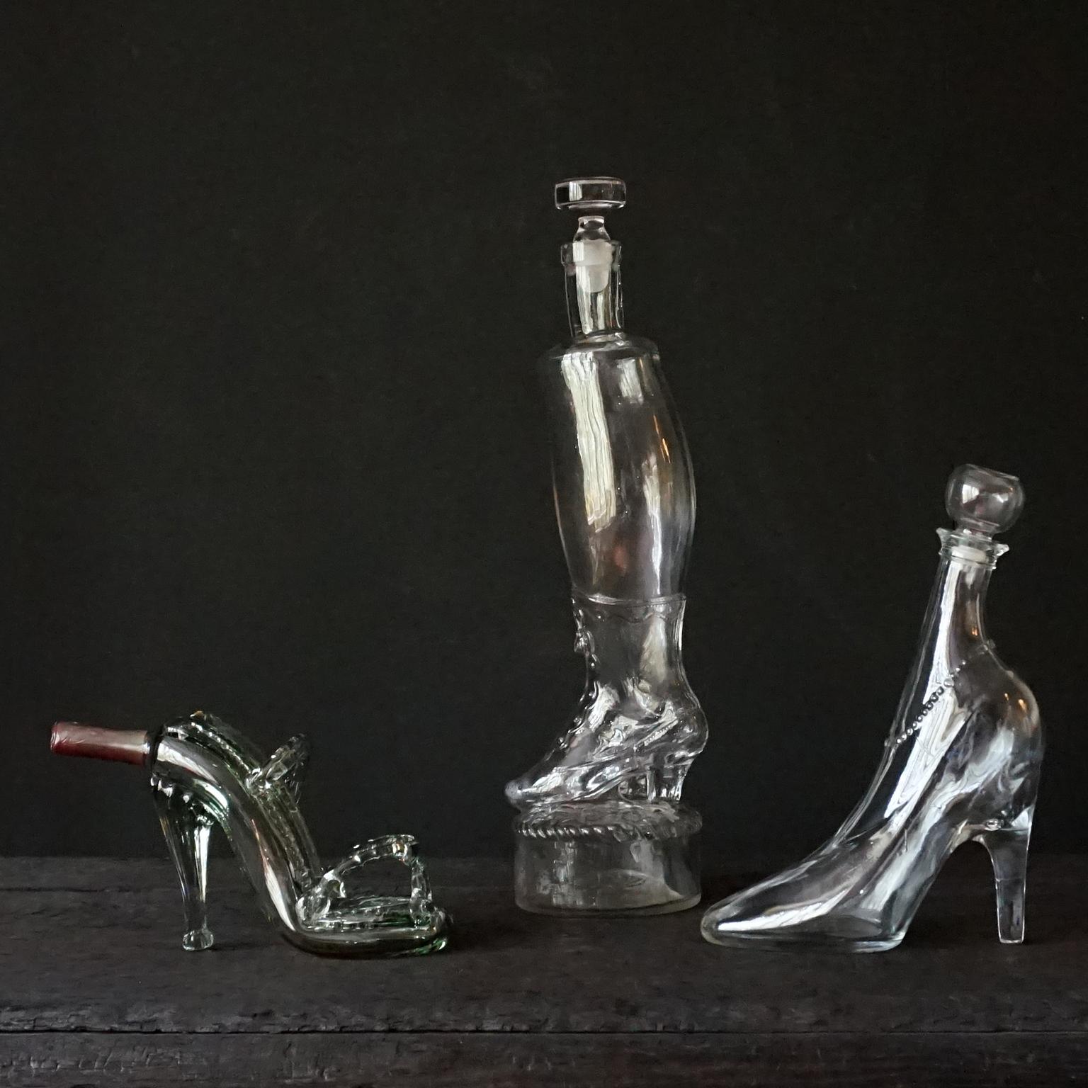 Set of three very pretty antique and vintage sexy Cinderella glass shoe bottles. 
A boot, a pump and a slipper.

It consists of a: 
-handblown in a mould Victorian 19th century Legras&Cie lady’s 