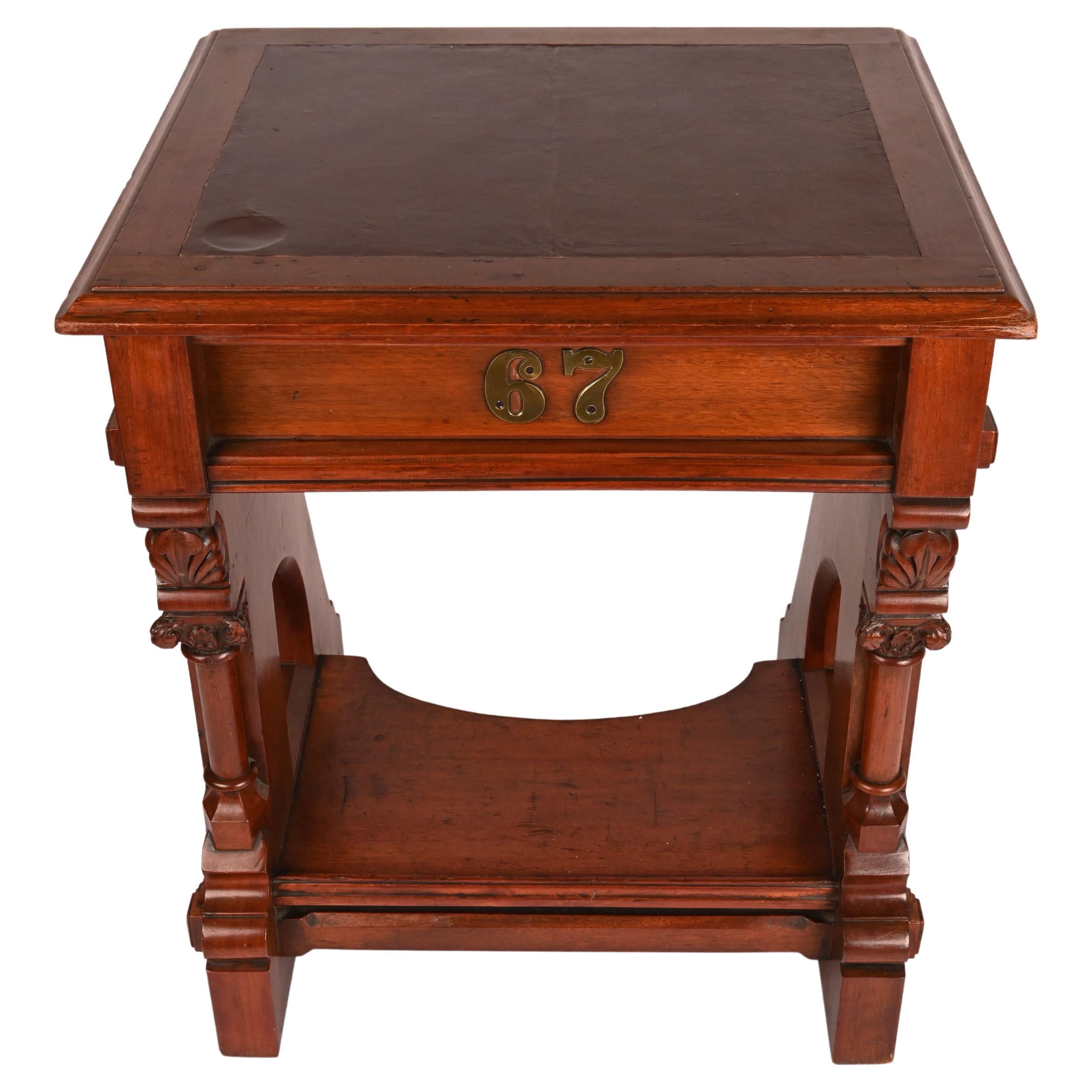 19th Century American carved cherry desk, designed by Leopold Eidlitz and made by Weller, Brown and Mesmer, Buffalo, New York, for the New York State Assembly Chamber. Front includes brass numerals ''67'' and the drawer bears several scrawled names