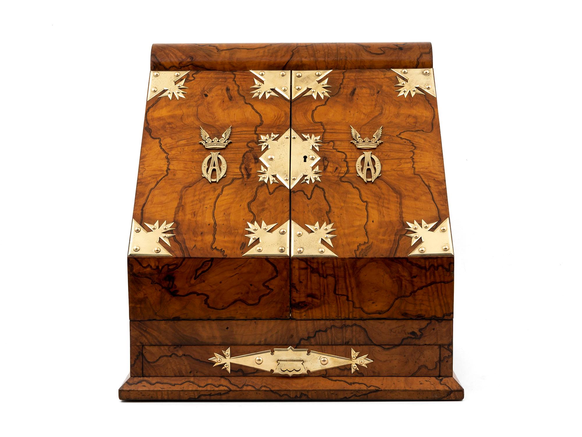 Unique large Stationery Box by Betjemann and retailed by Leuchars, with a Duke's Coronet.

This wonderful stationery box is veneered in feathered Olivewood, ornate brass mounts, and wonderfully made large carry handles. With a winged Duke's crown