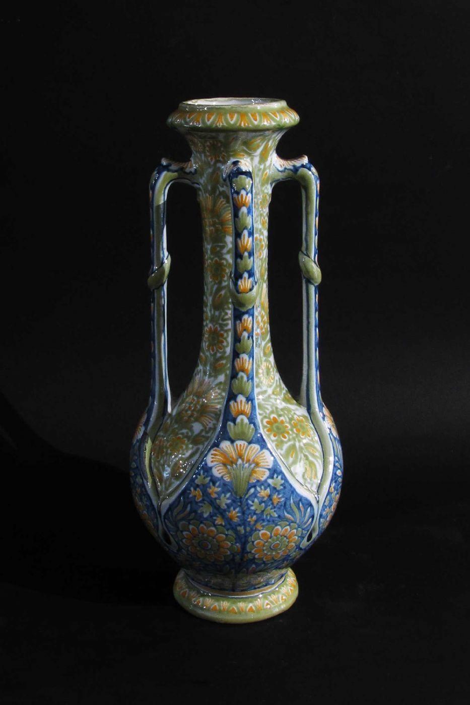 Characteristic four-handled polychrome majolica vase born from the artistic collaboration of Gibus and M. Redon. The object represents a fusion of Neo-Renaissance and Art Nouveau features. Mark bearing the monogram of the artistic collaboration