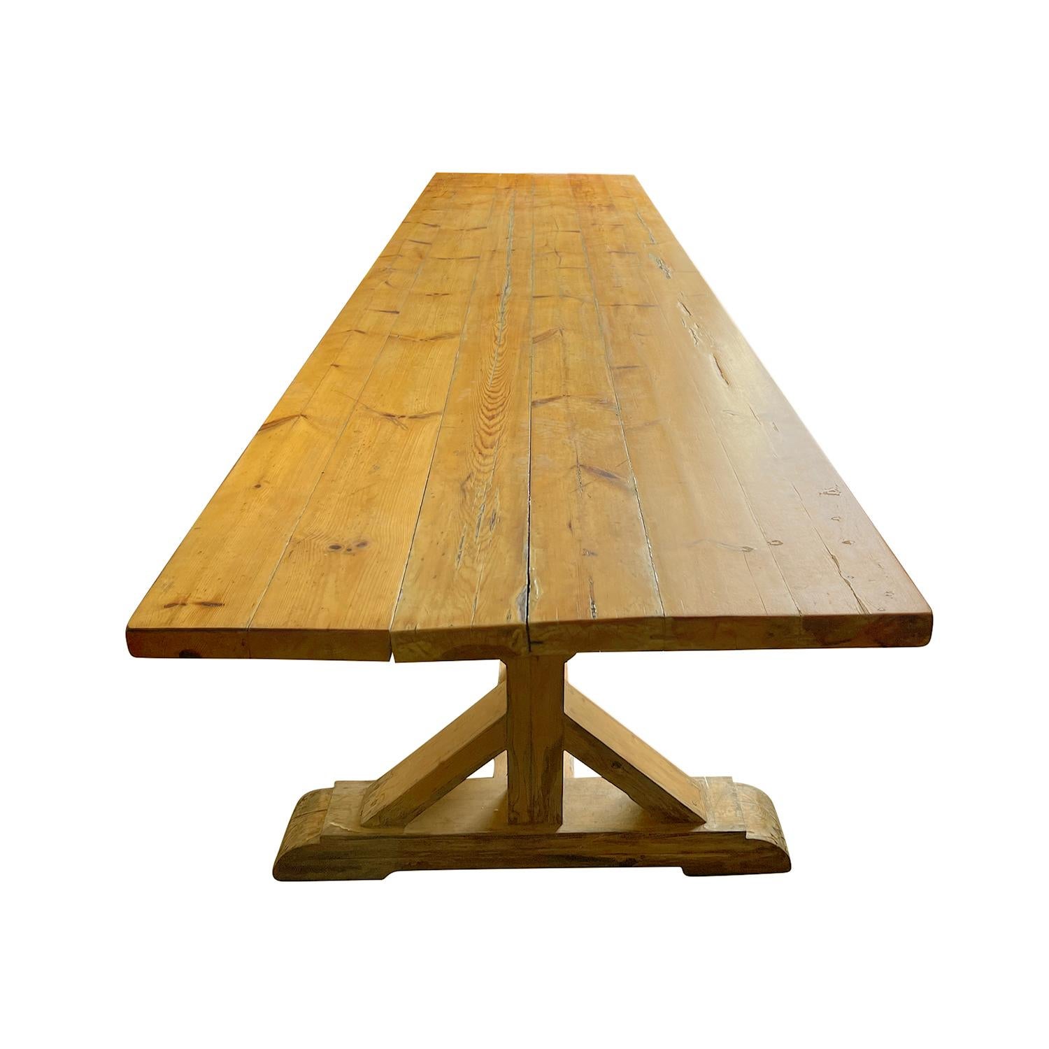An important and substantial French Provincial Oakwood trestle table with base construction, in good condition. This antique table has very clean and strong lines and proportions. The table top rests upon a framework that is supported by three bell
