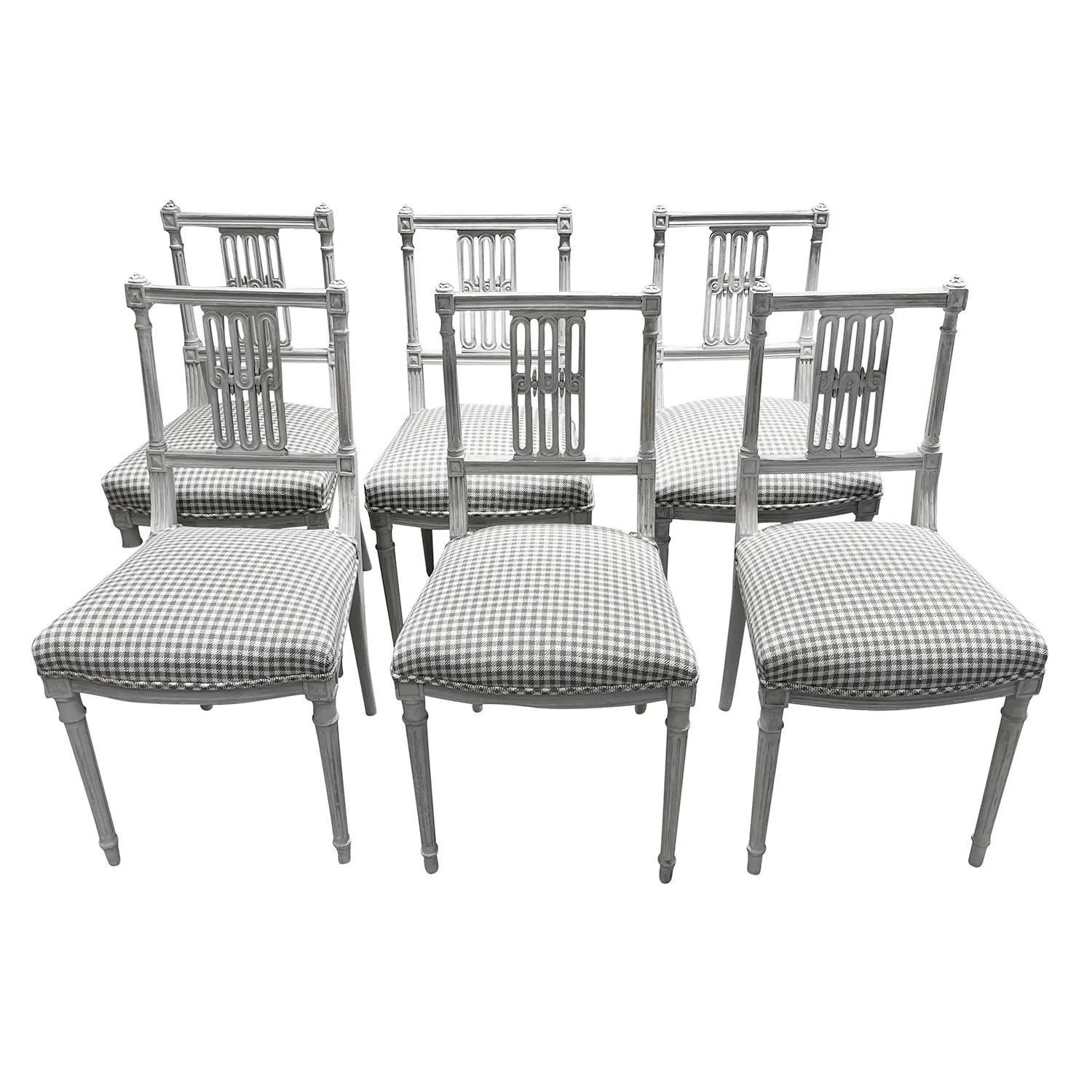 A light-grey, antique Danish set of six small side or Boudoir chairs in a chalky grey finish with square backrests and a centered floral decoration, possibly Denmark. The Scandinavian dining end chairs are made of hand carved Pinewood in good