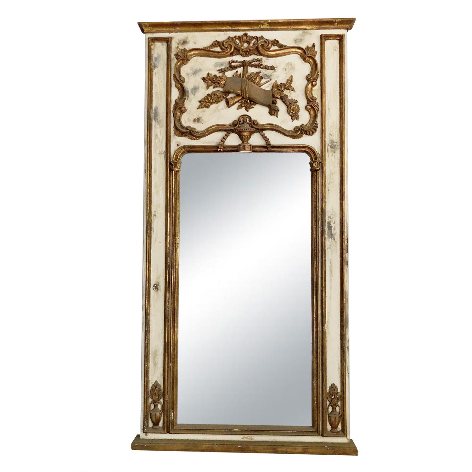 This 19th Century, antique Trumeau Louis XV style gilded Pinewood mirror has a white wash finish, enhanced by very detailed wood carvings, in good condition. The mirrored glass is original. Minor fading, due to age. Wear consistent with age and use.