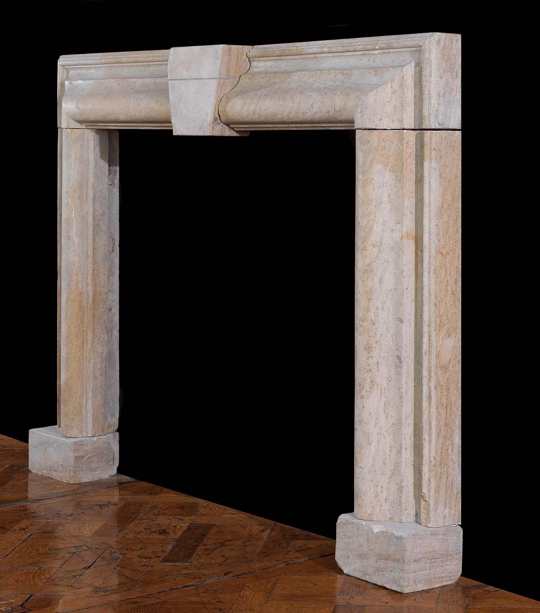 A substantial Bolection chimneypiece carved from beautiful soft grey, salmon brown and taupe Derbyshire Fossil Limestone with a large central keystone. This stone is quite hard and will take a polish. English, circa 1860.

Notes: Derbyshire Fossil