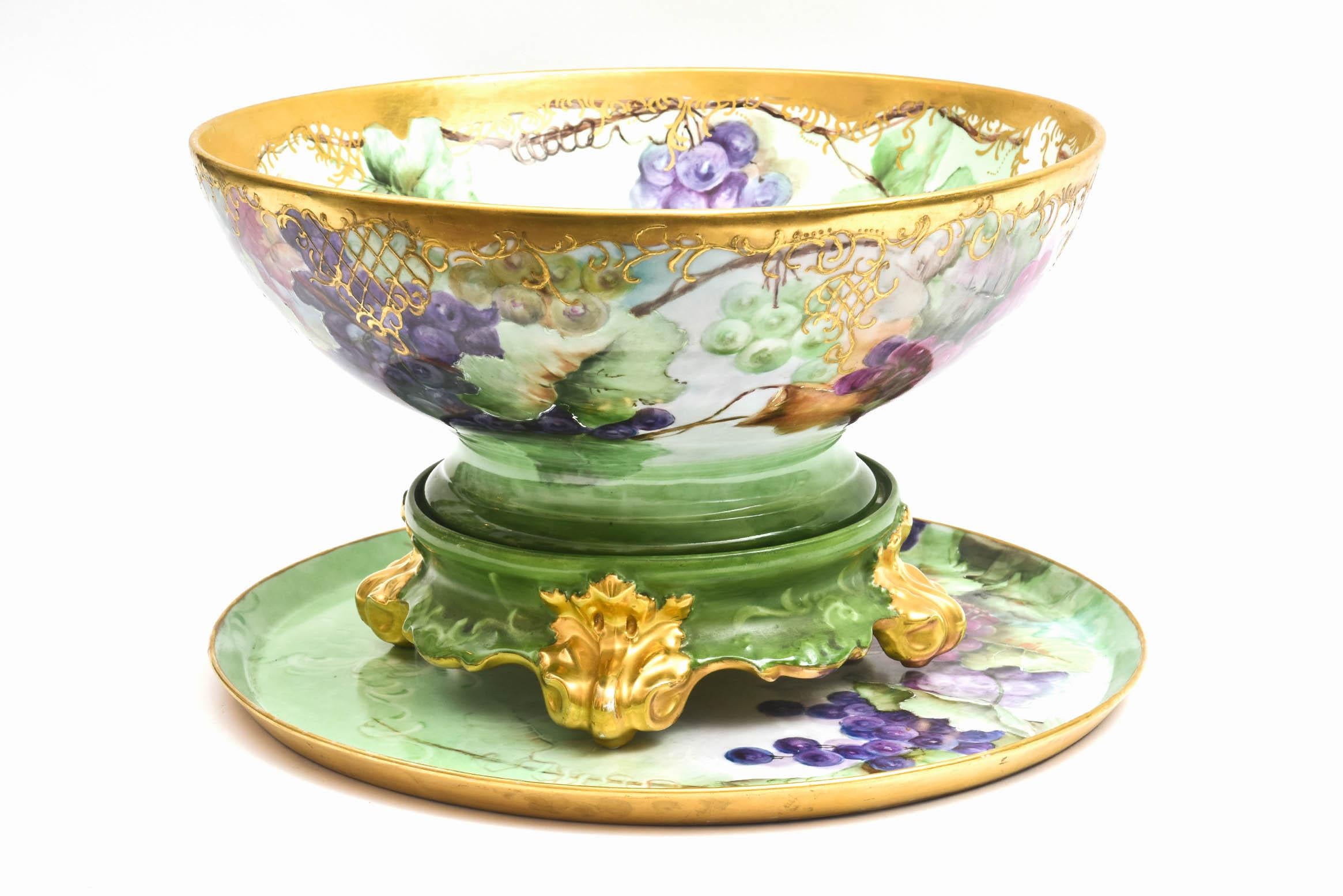 Late Victorian period era punch bowl and or centerpiece vividly hand painted. It is so hard to find all 3 pieces together. All over hand painted with raised gilt accents and a nicely shaped pedestal bowl with a stand featuring richly gilded feet.