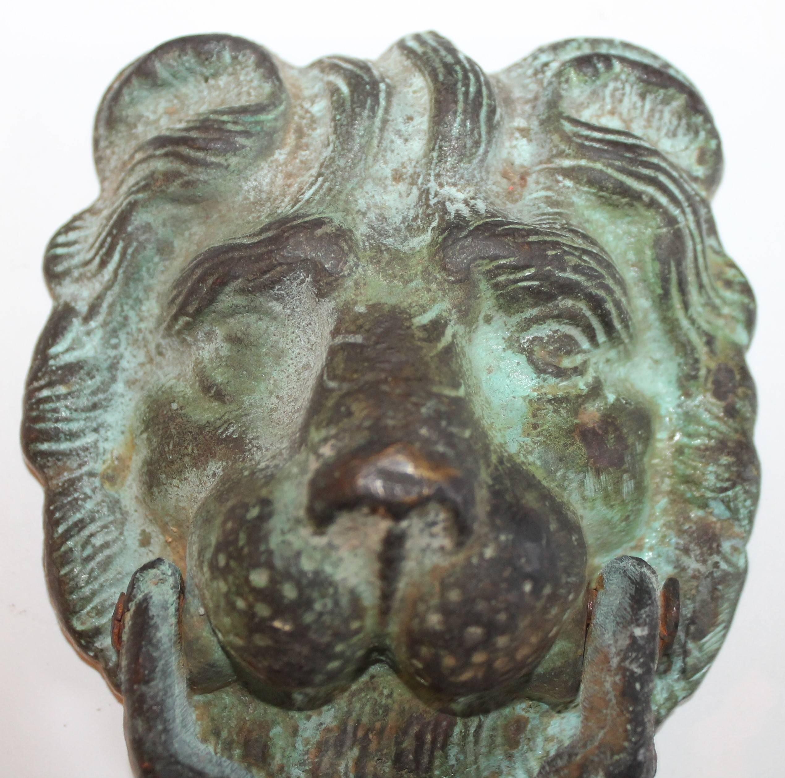 19th century lion door knocker. This door knocker is in great condition and has wear consistent with age and use. There is great patina to the bronze. Great working condition.